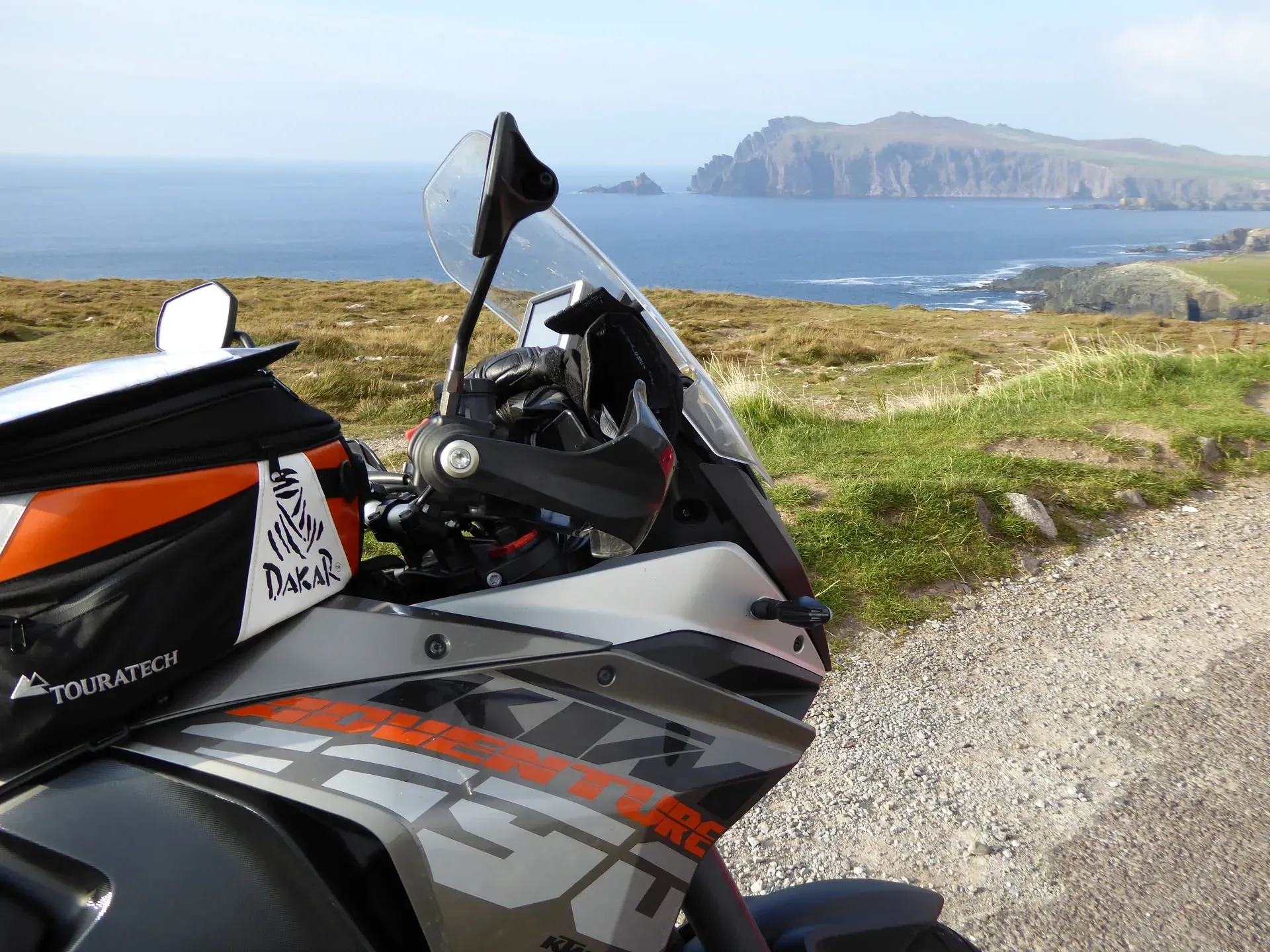 KTM motorcycle parked at Dunurlin, Ireland coastal cliffs