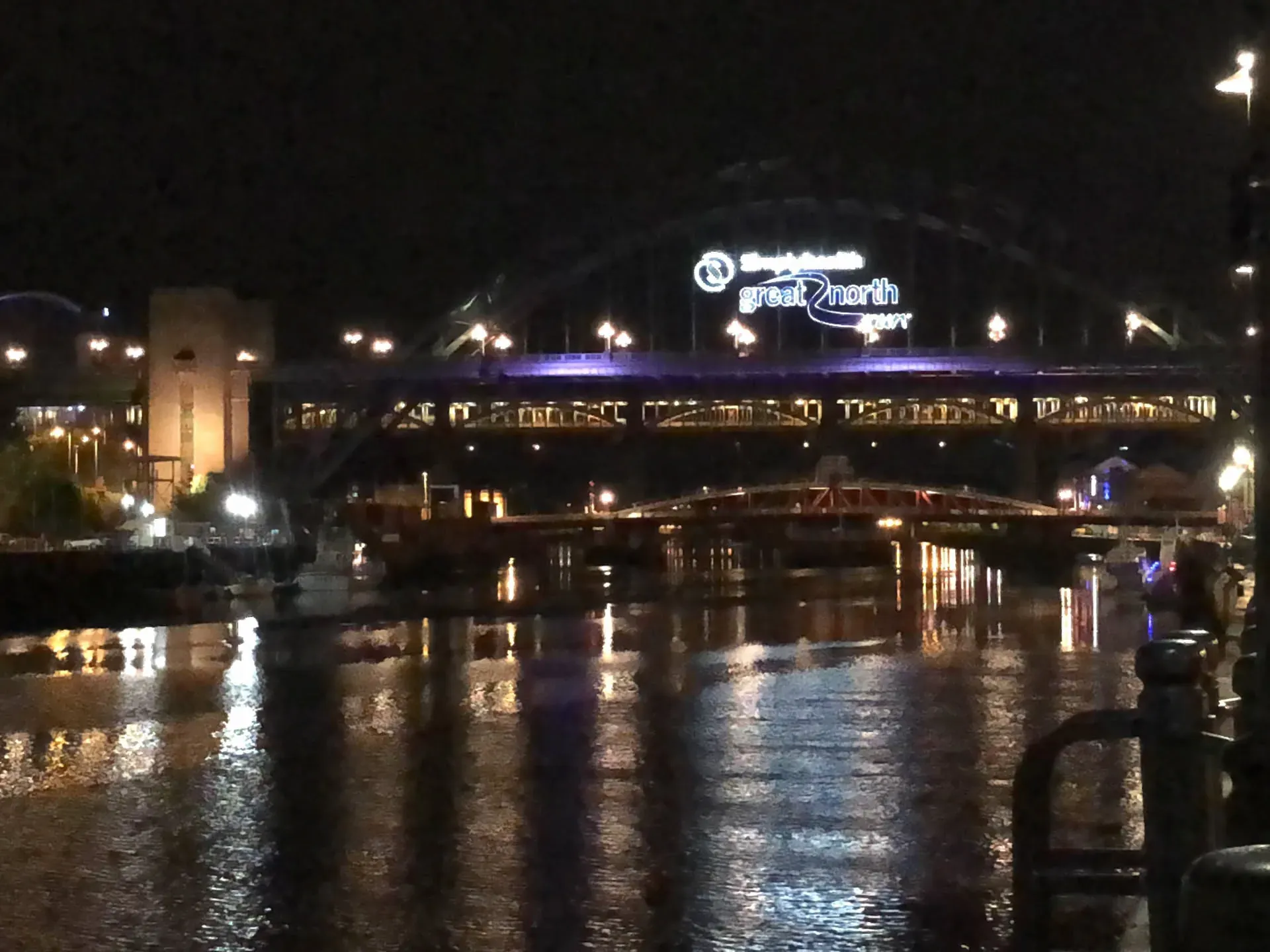 Night view of Great North Museum across lit river, Battlefield