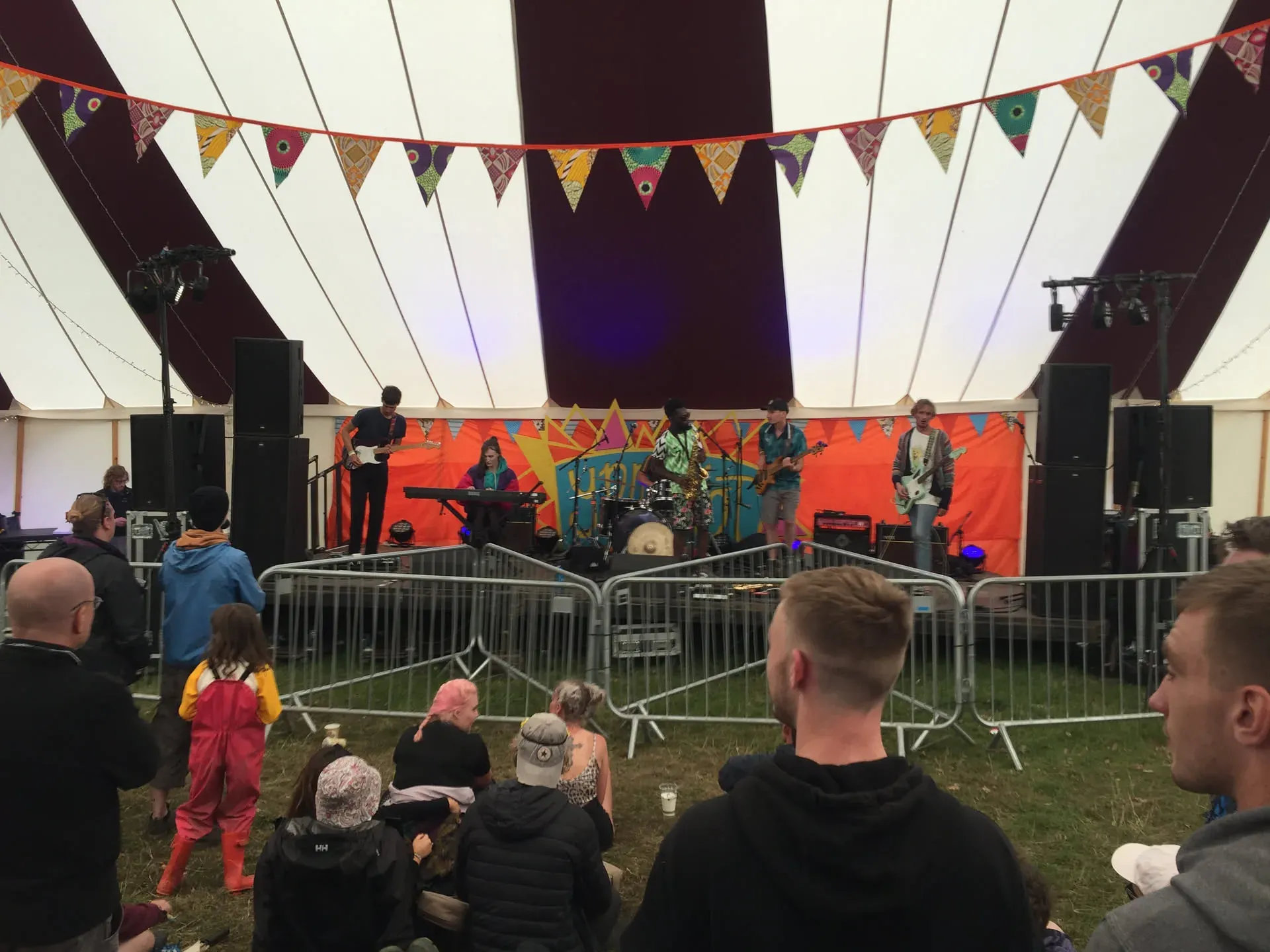 Band performing in festival tent with audience