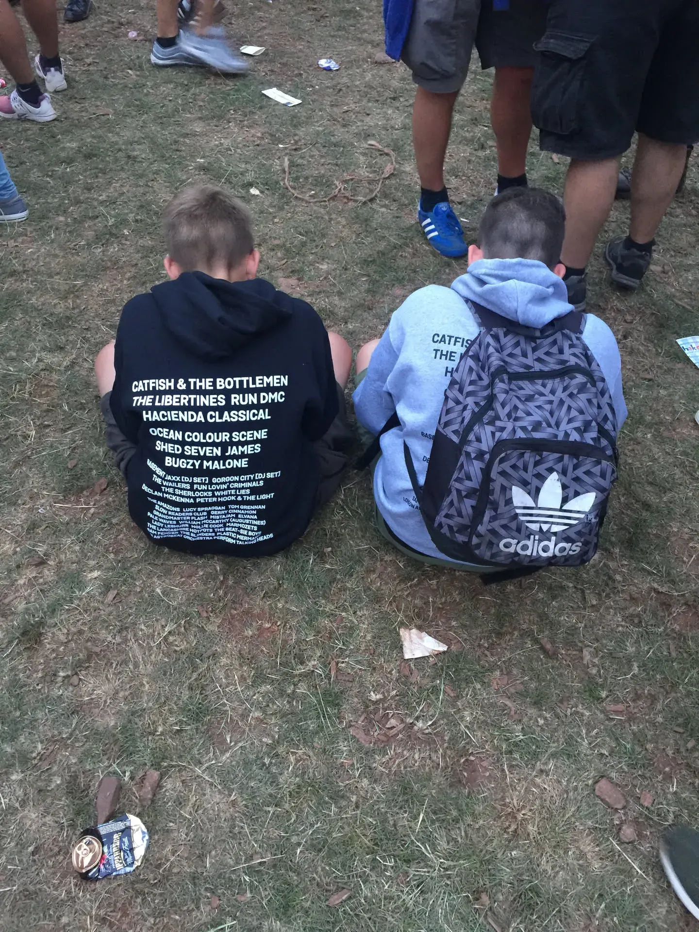 Two young boys sitting on grass at Lowther festival