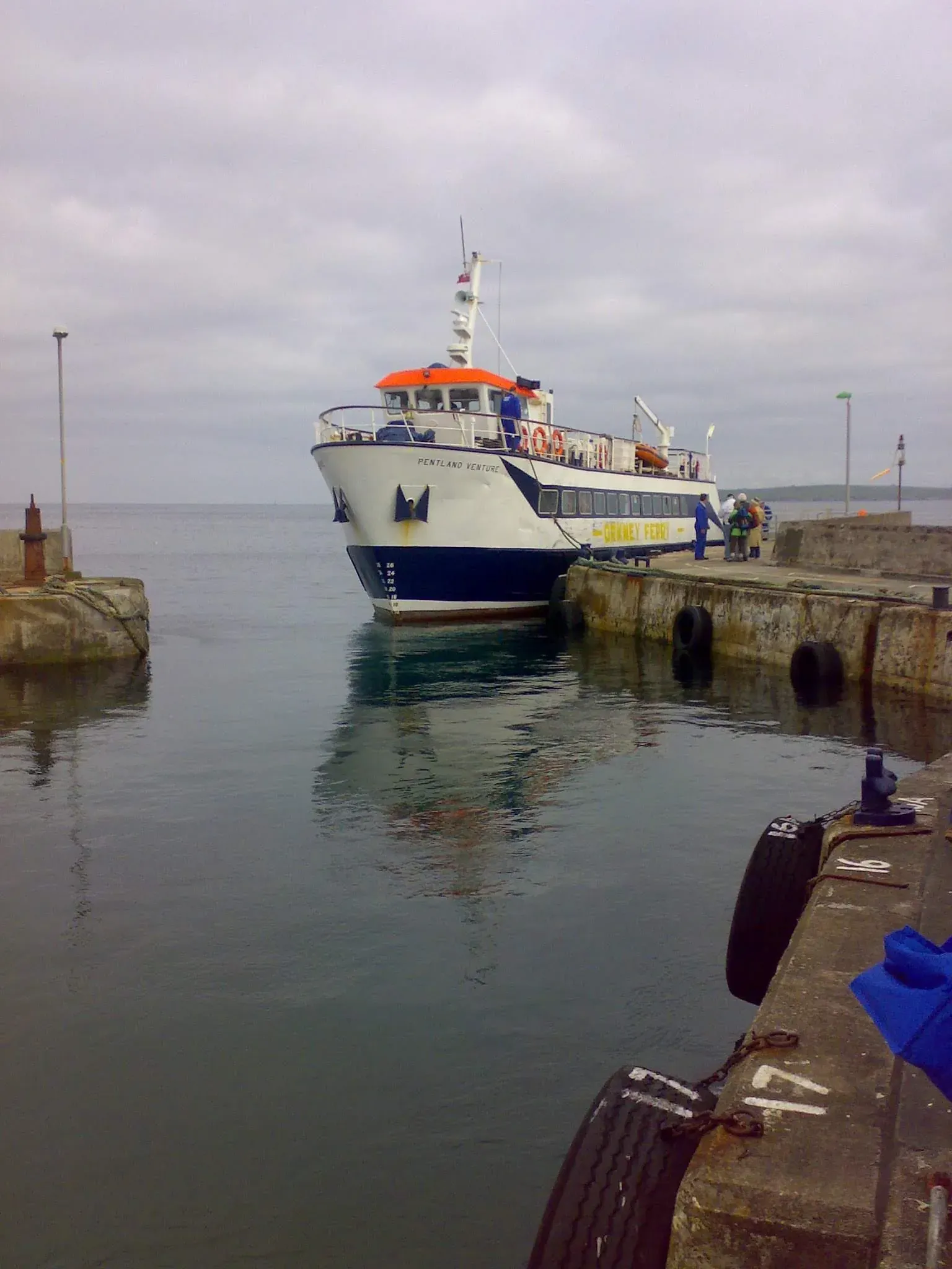 Pentland Venture ferry docked at stone pier