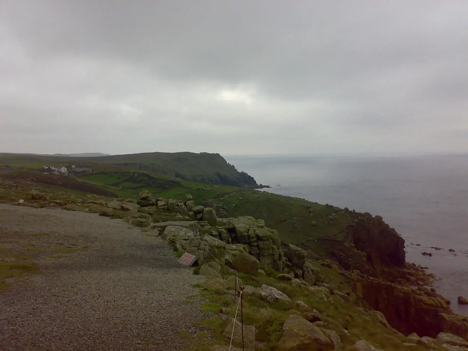 Coastal cliffs and green fields at Sennen Cove