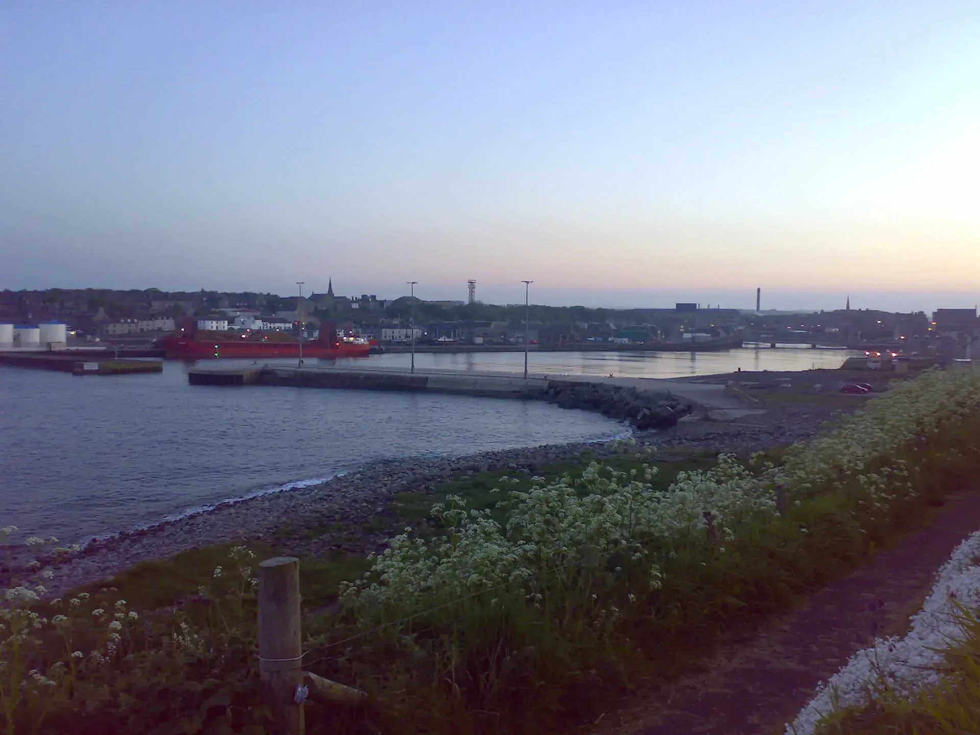 Red ship at Willowbank harbor at dusk