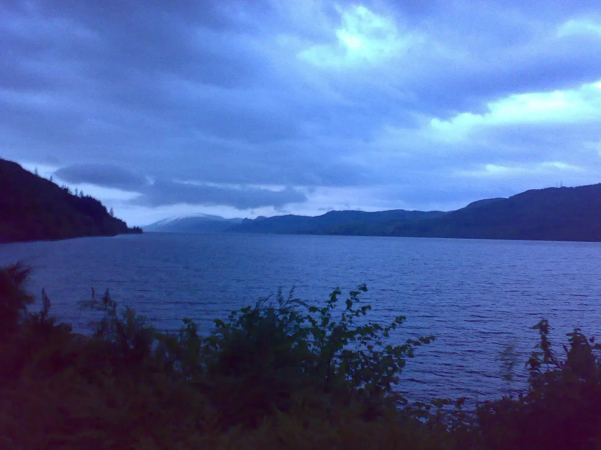 Twilight over a Scottish loch with mountains