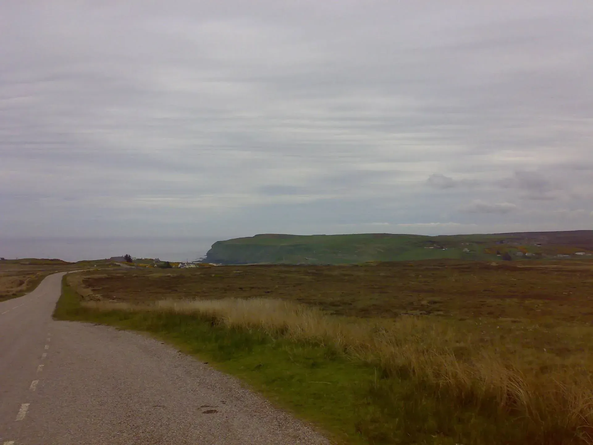 Rural road with green cliffs in distance