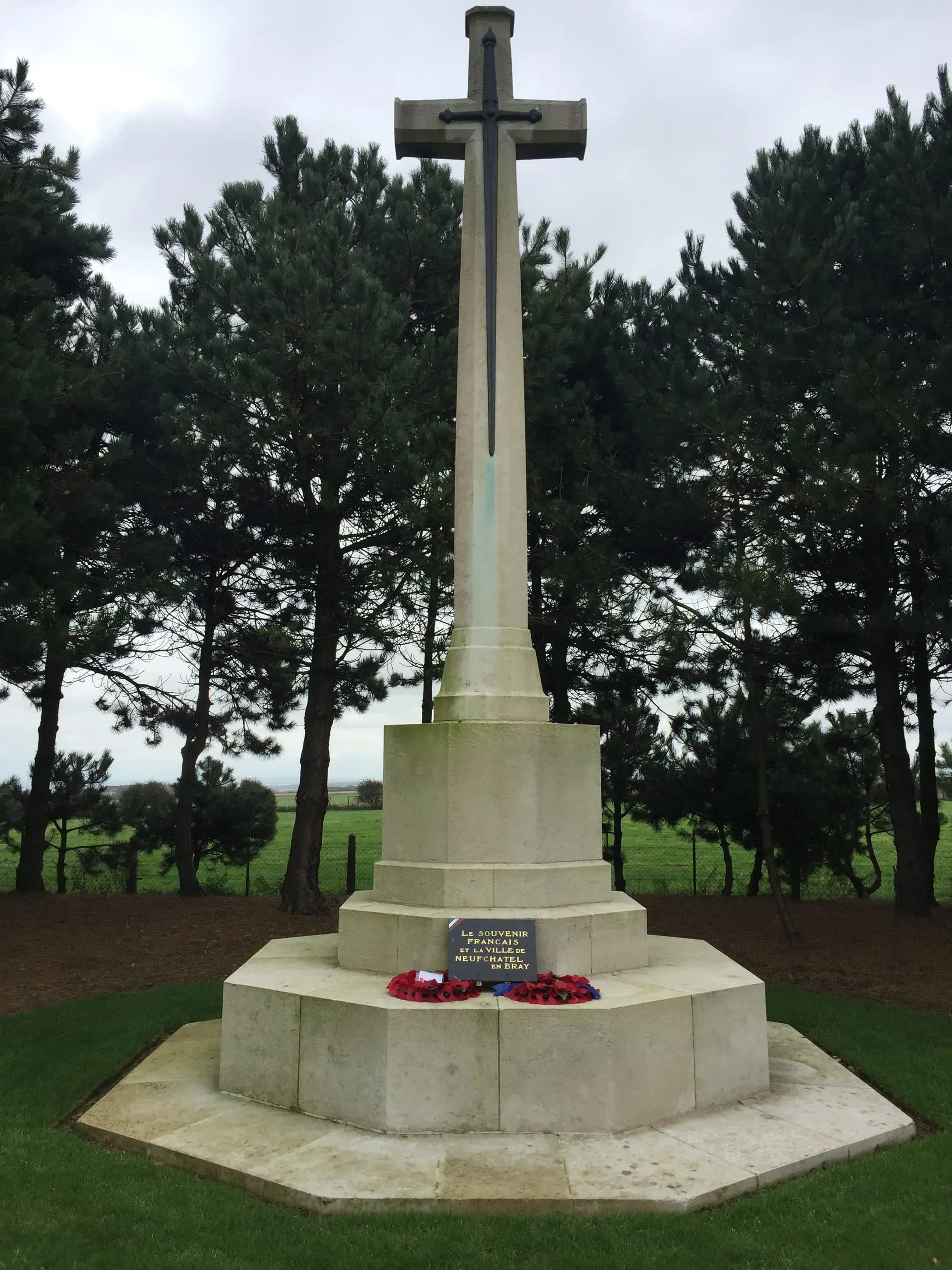 War memorial cross in Leubringhen with fresh wreaths