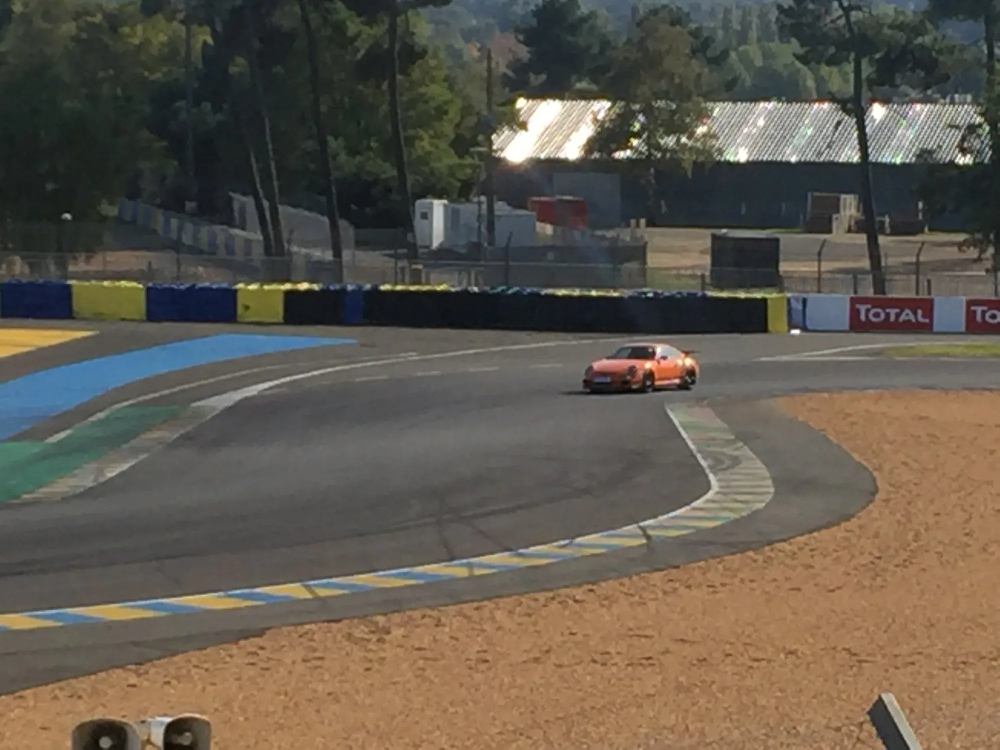 Red sports car on Le Mans circuit at Le Houx