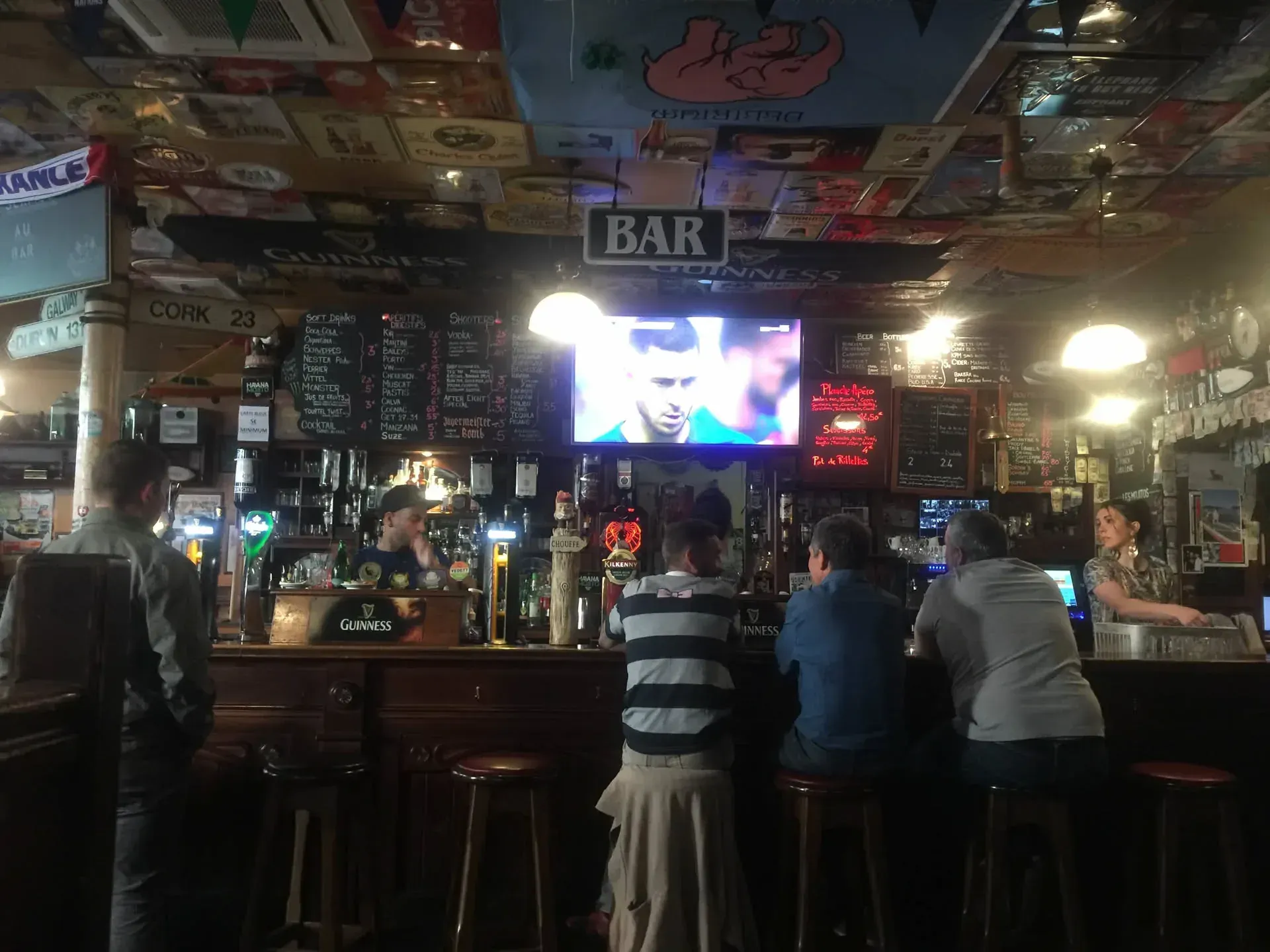 Inside Irish pub at Courboulay, patrons at bar counter