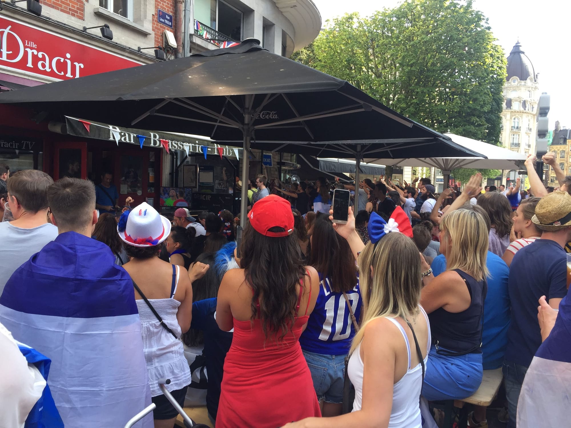 Crowd celebrating at Lille-Centre bar brasserie