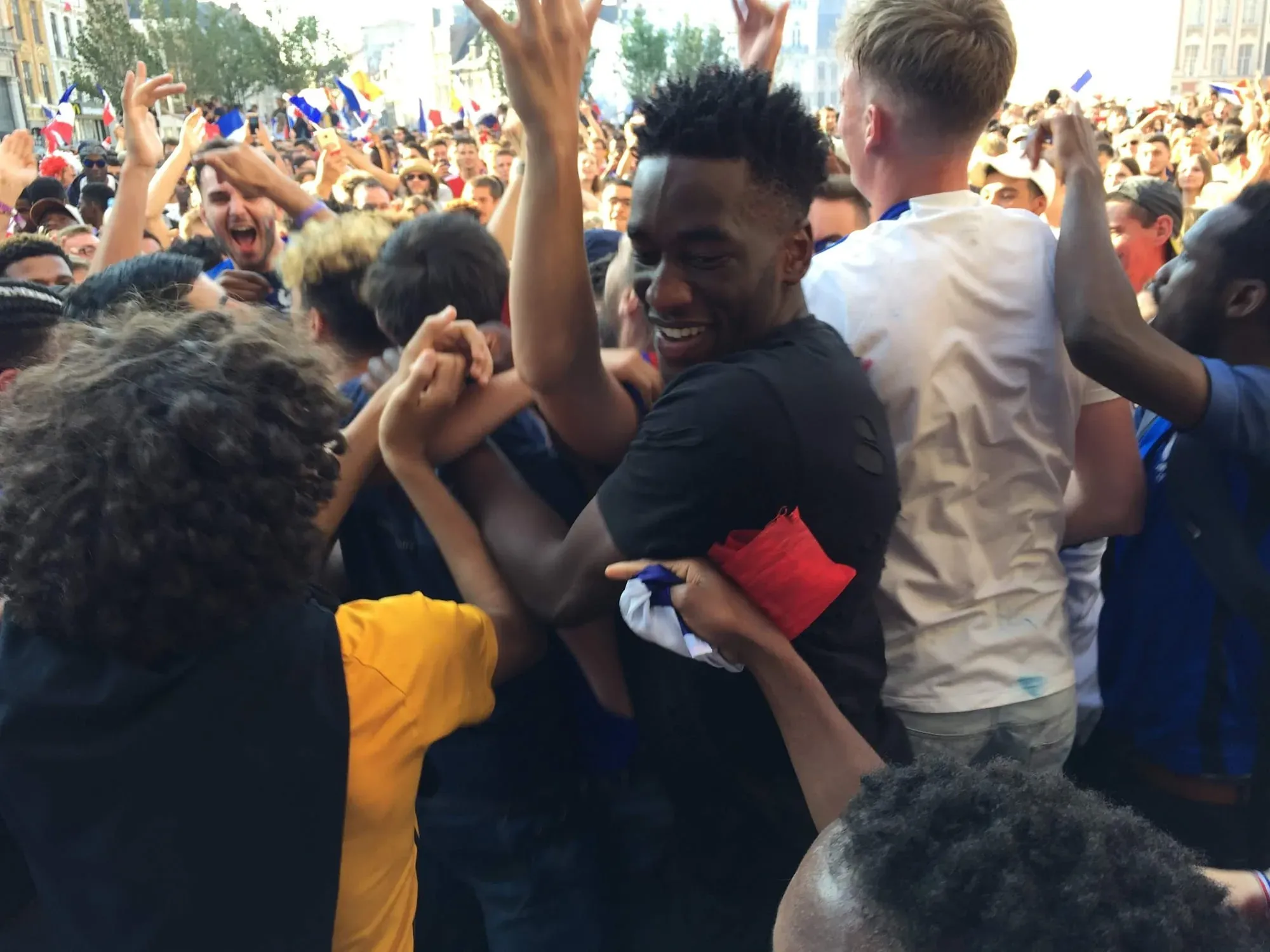 Crowd celebrating with French flags at Lille-Centre