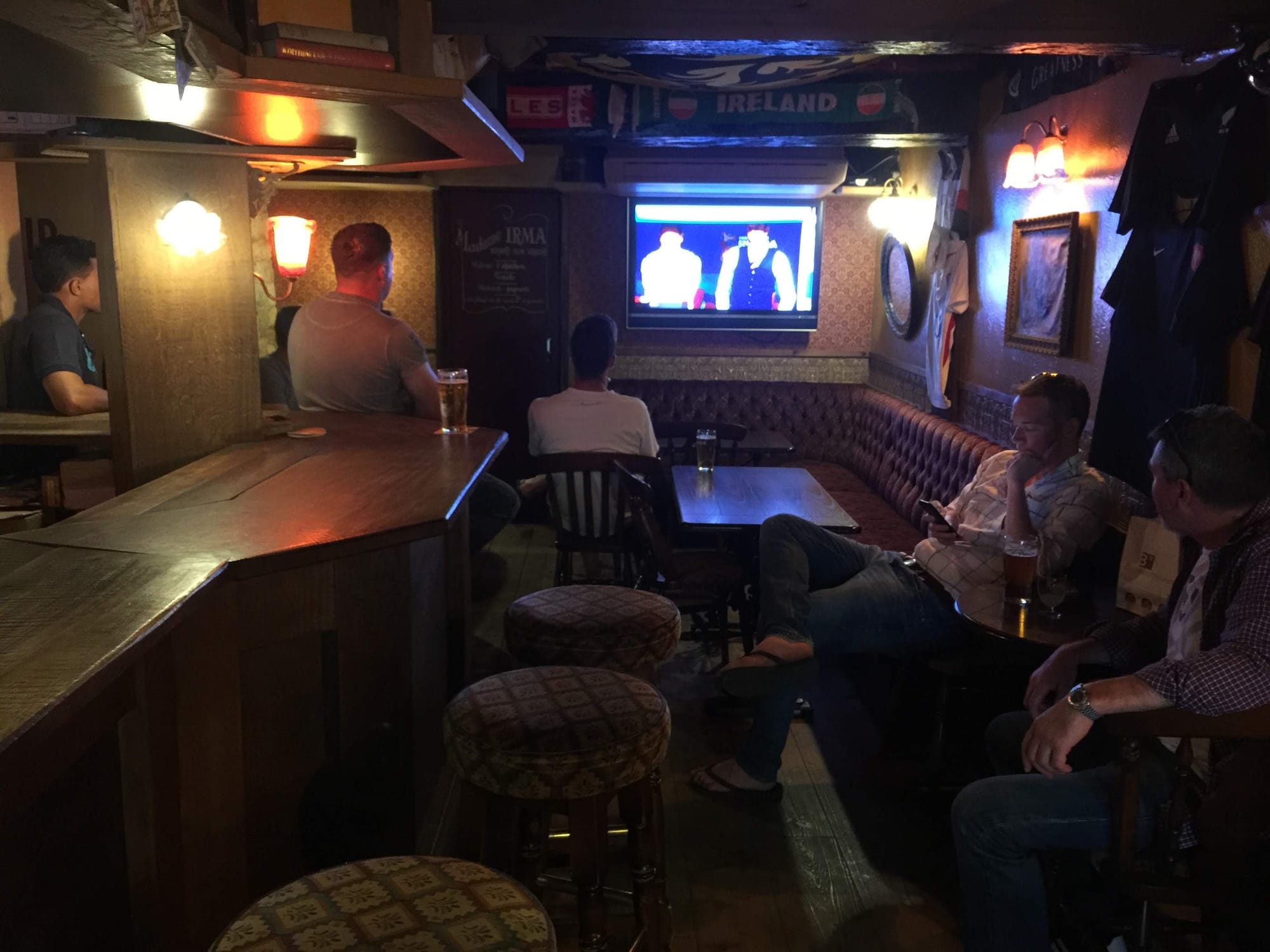 Irish pub interior in Bayeux with TV and patrons