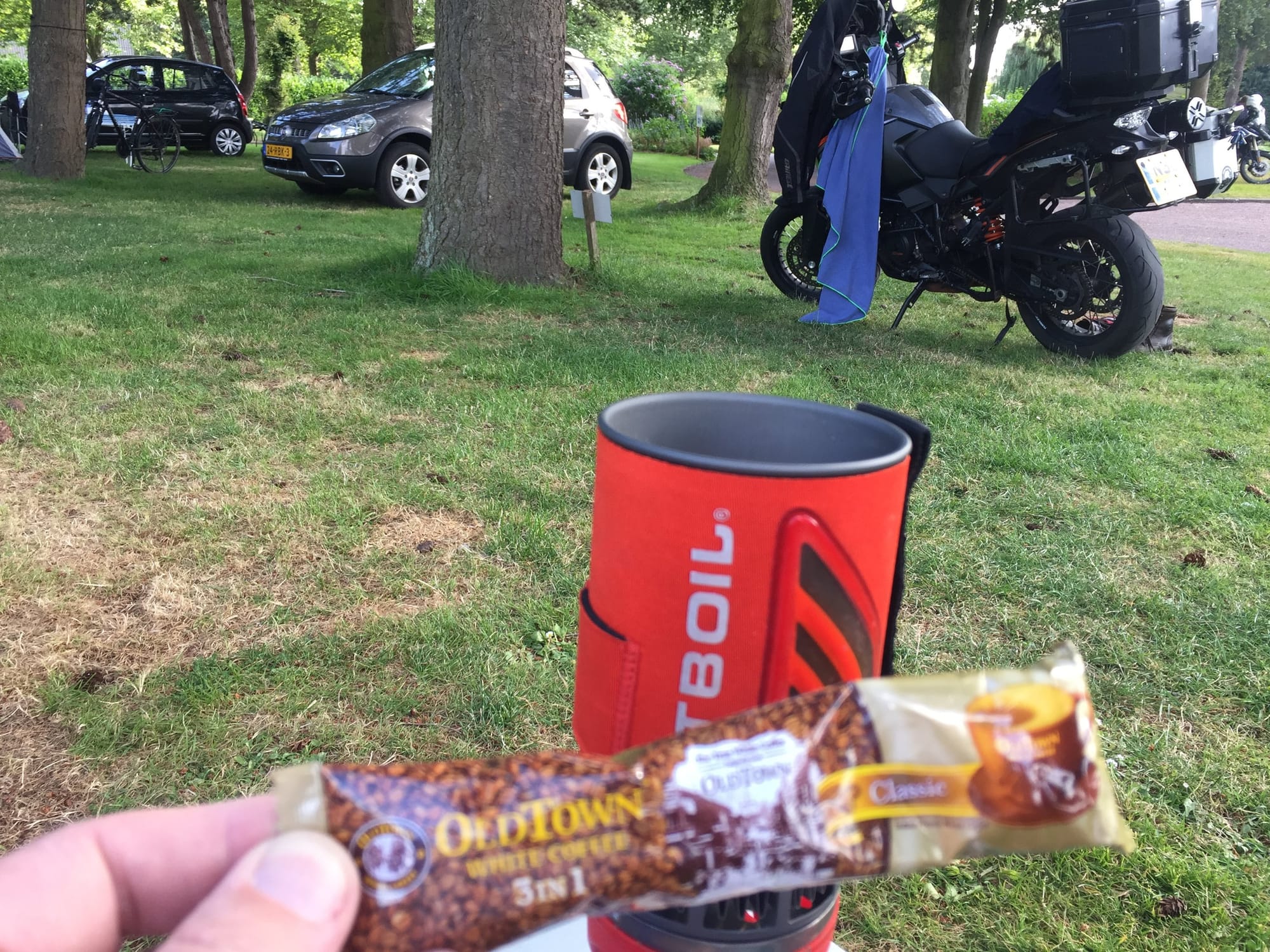 Snacks and cooler at Argouges picnic gathering with motorcycle