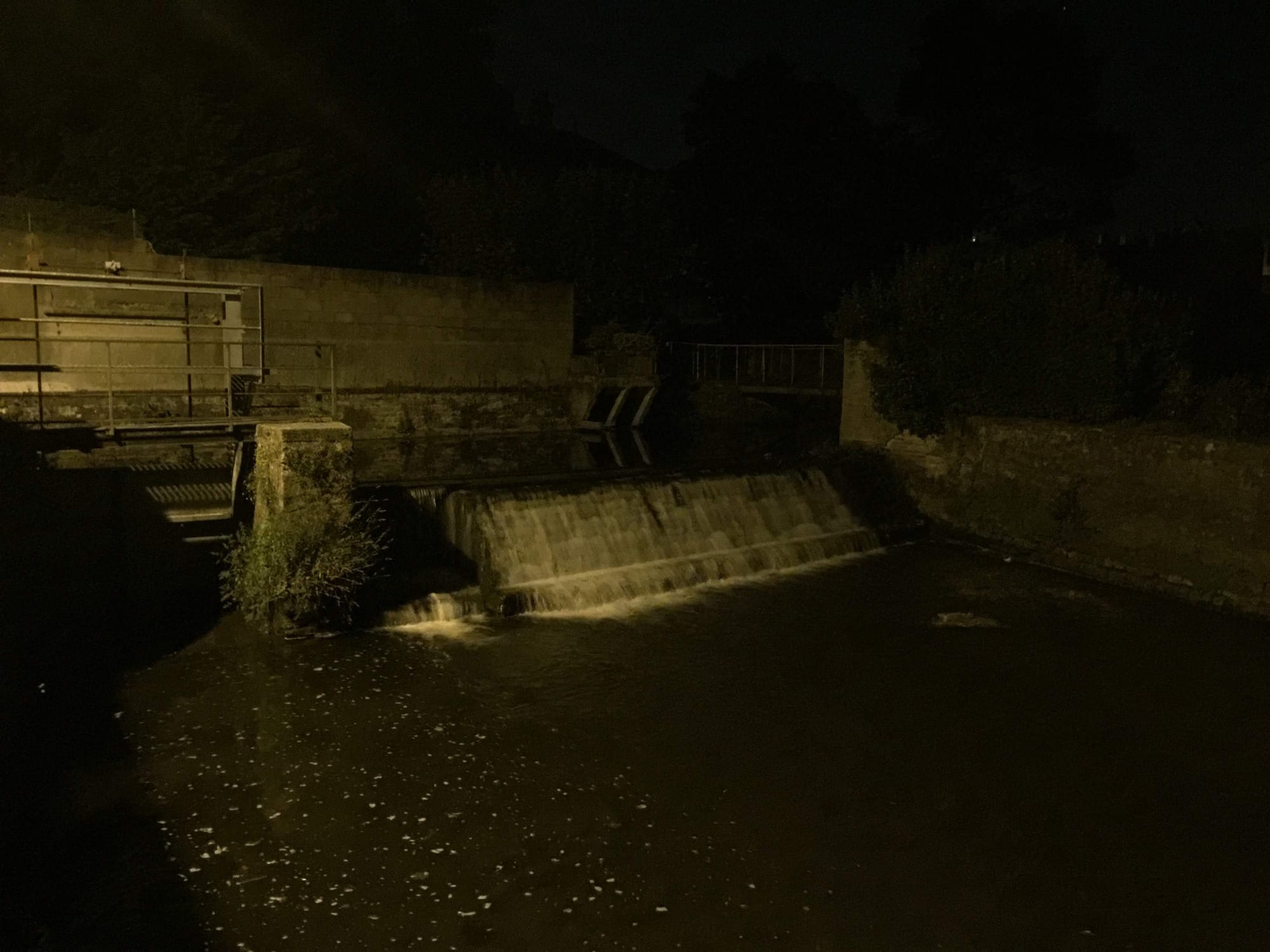 Nighttime view of dam and weir at Résidence, Normandy