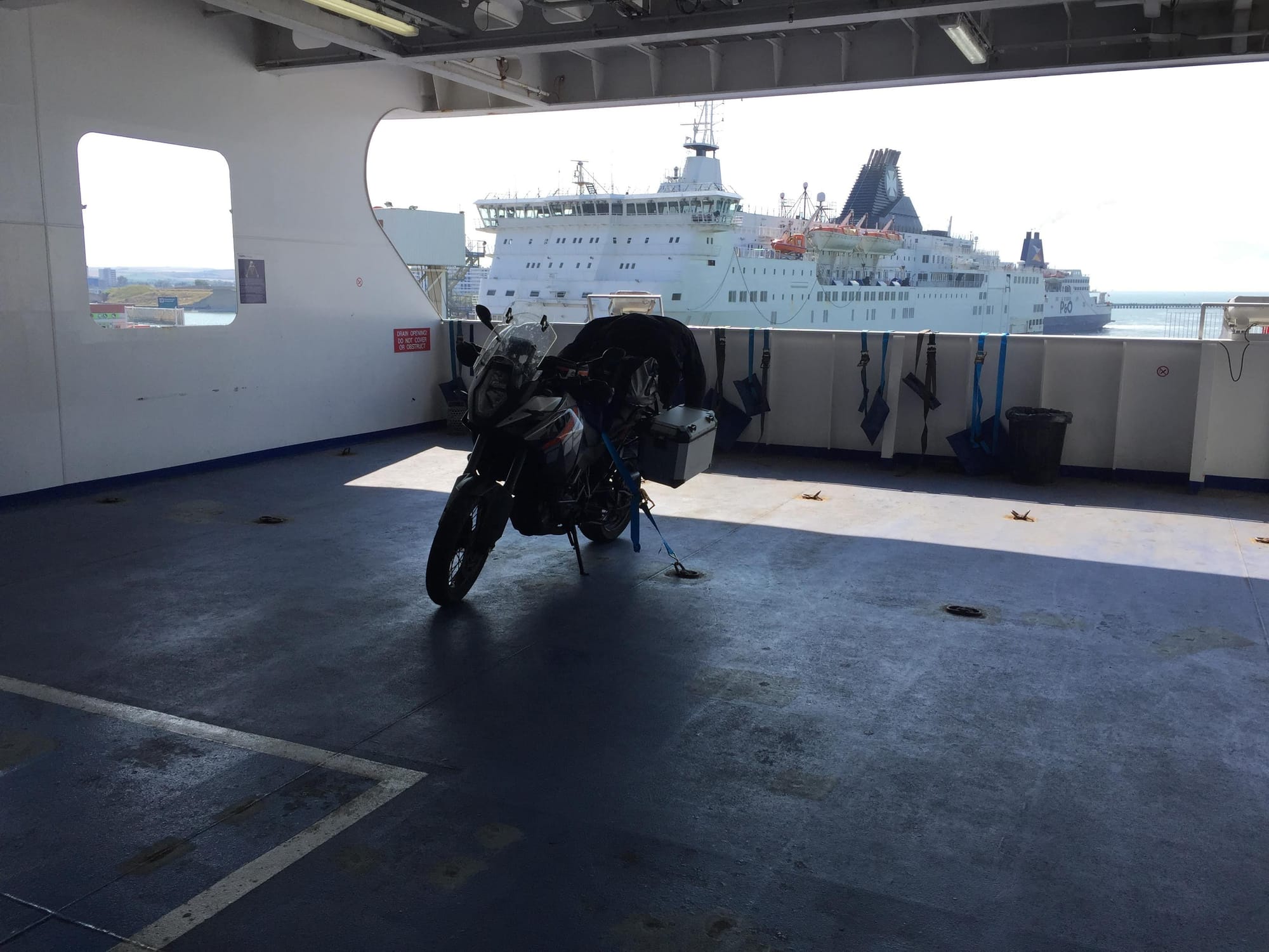 Black motorcycle parked on ferry deck, Hauts-de-France