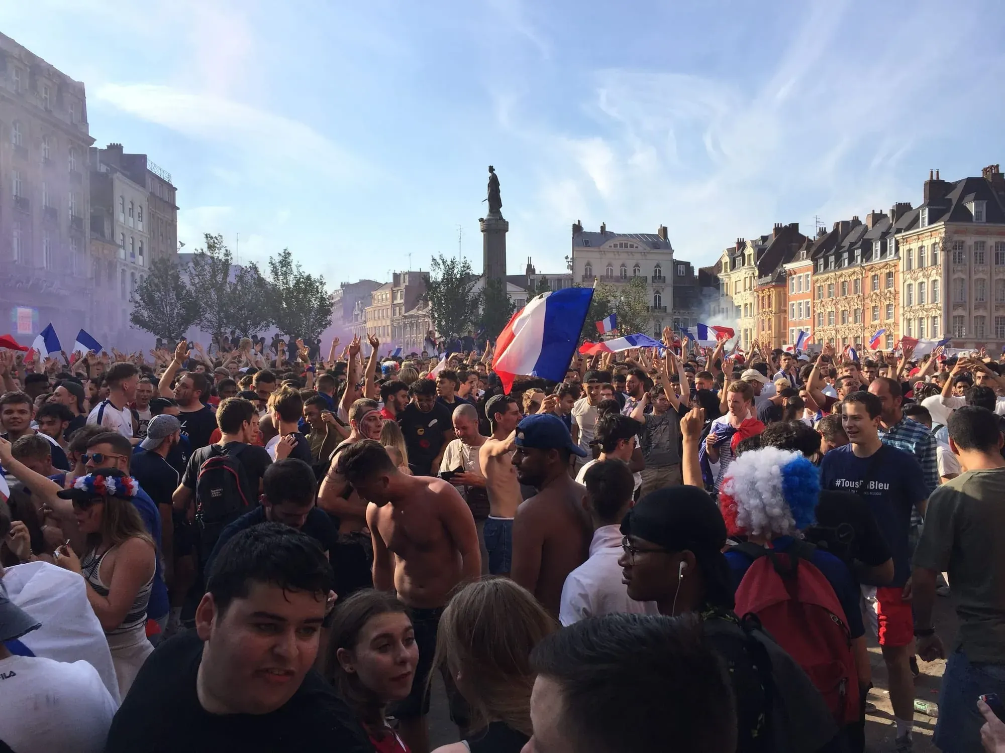 Large crowd celebrating with French flags in Lille-Centre