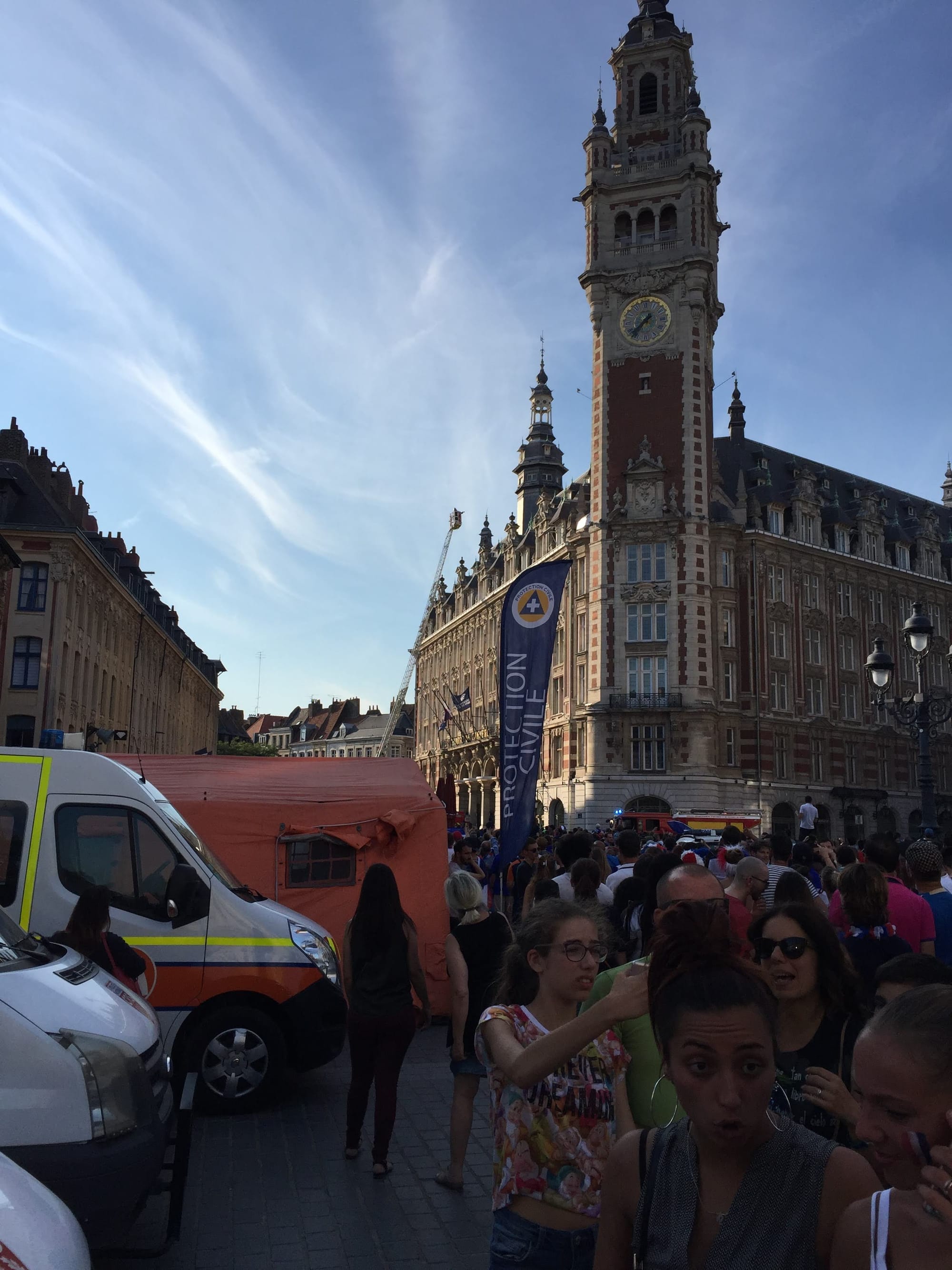 Clock tower and crowds in Lille-Centre square