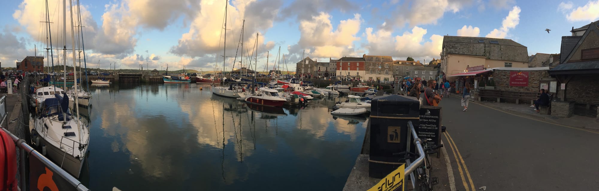 Sailboats moored in Padstow harbor at sunset
