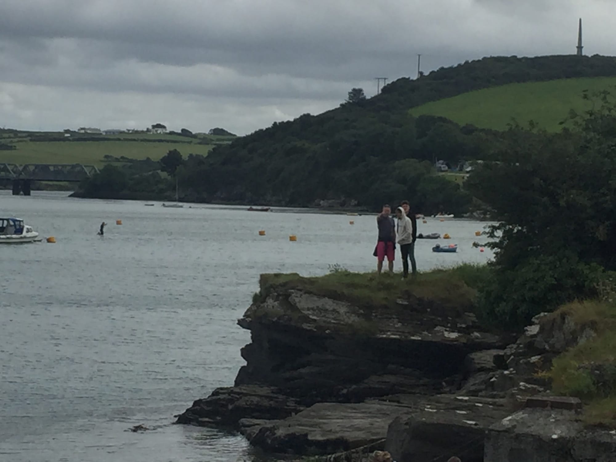 Two people standing on rocky shore at Padstow