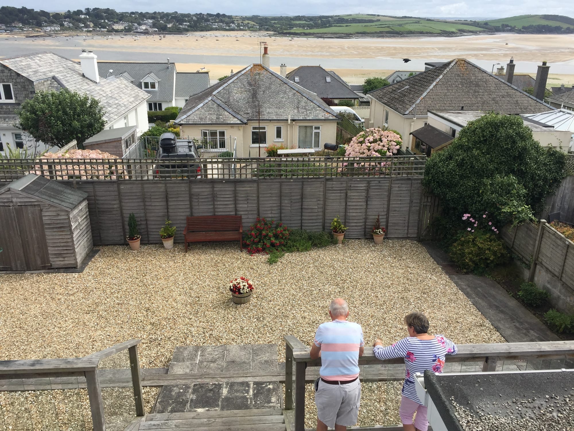 Two people viewing beach from Padstow garden