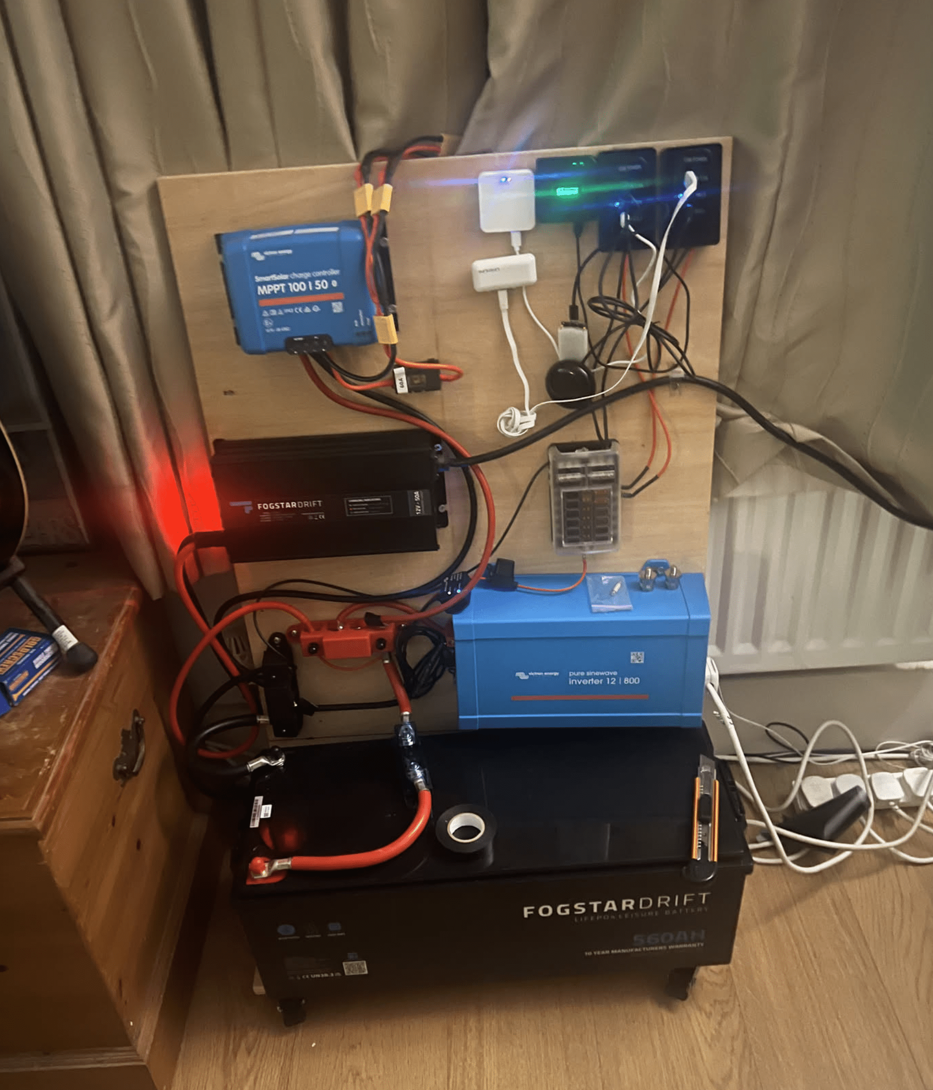 Indoor setup early on — Victron MPPT, Fogstar battery and inverter before cable tidy