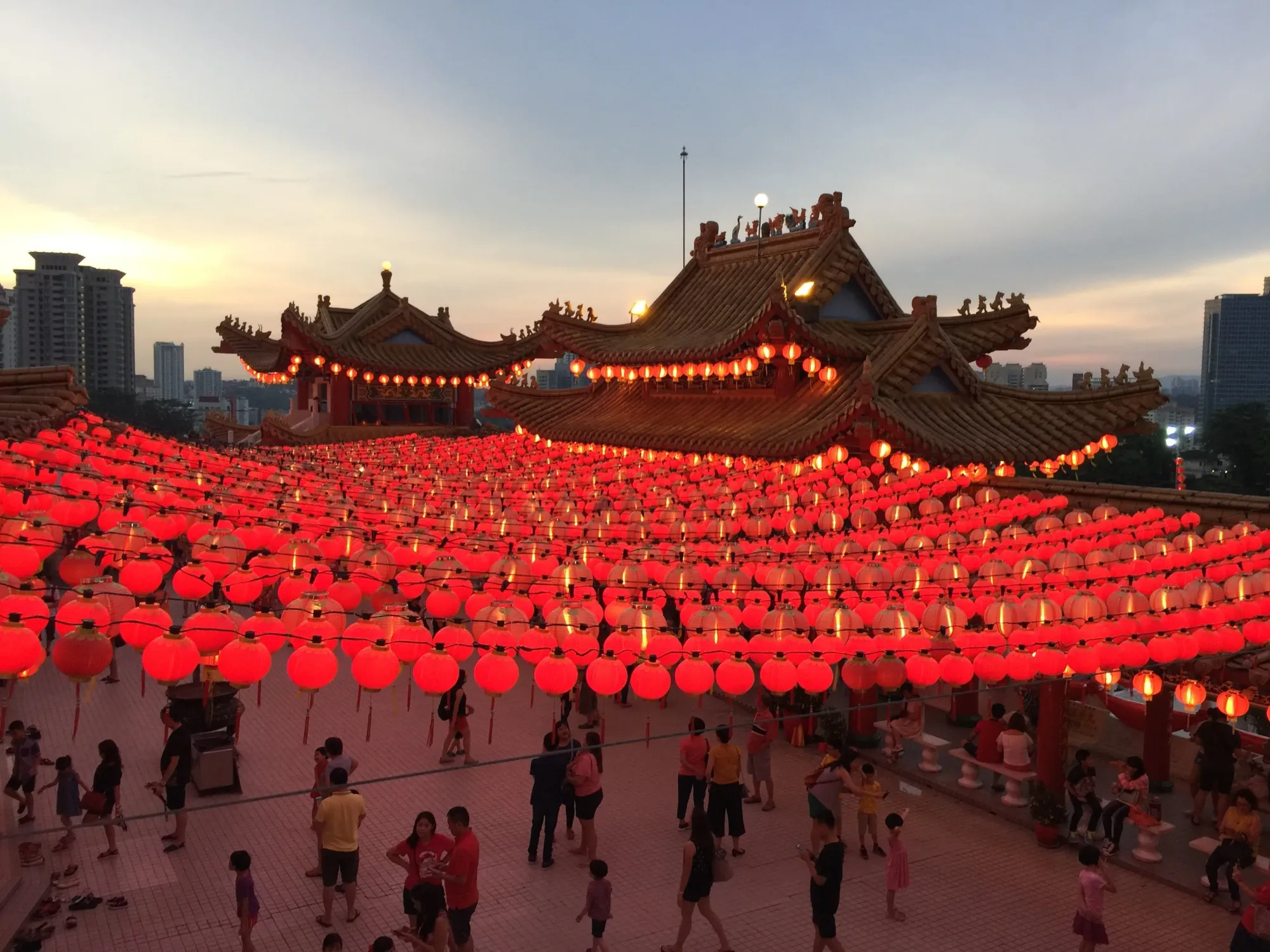 Illuminated red lanterns at Chinese temple during dusk