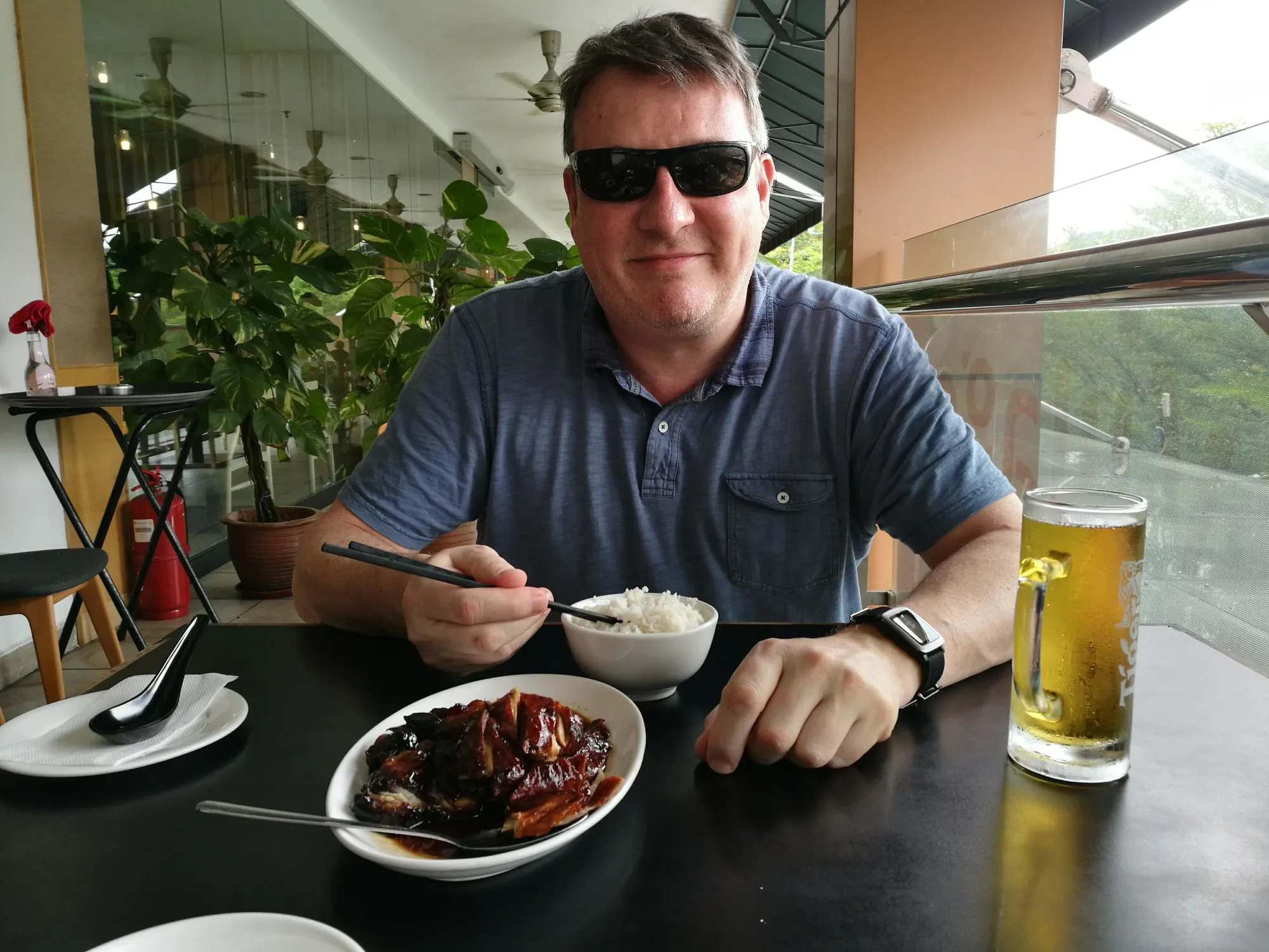 Man eating Asian food at a modern restaurant