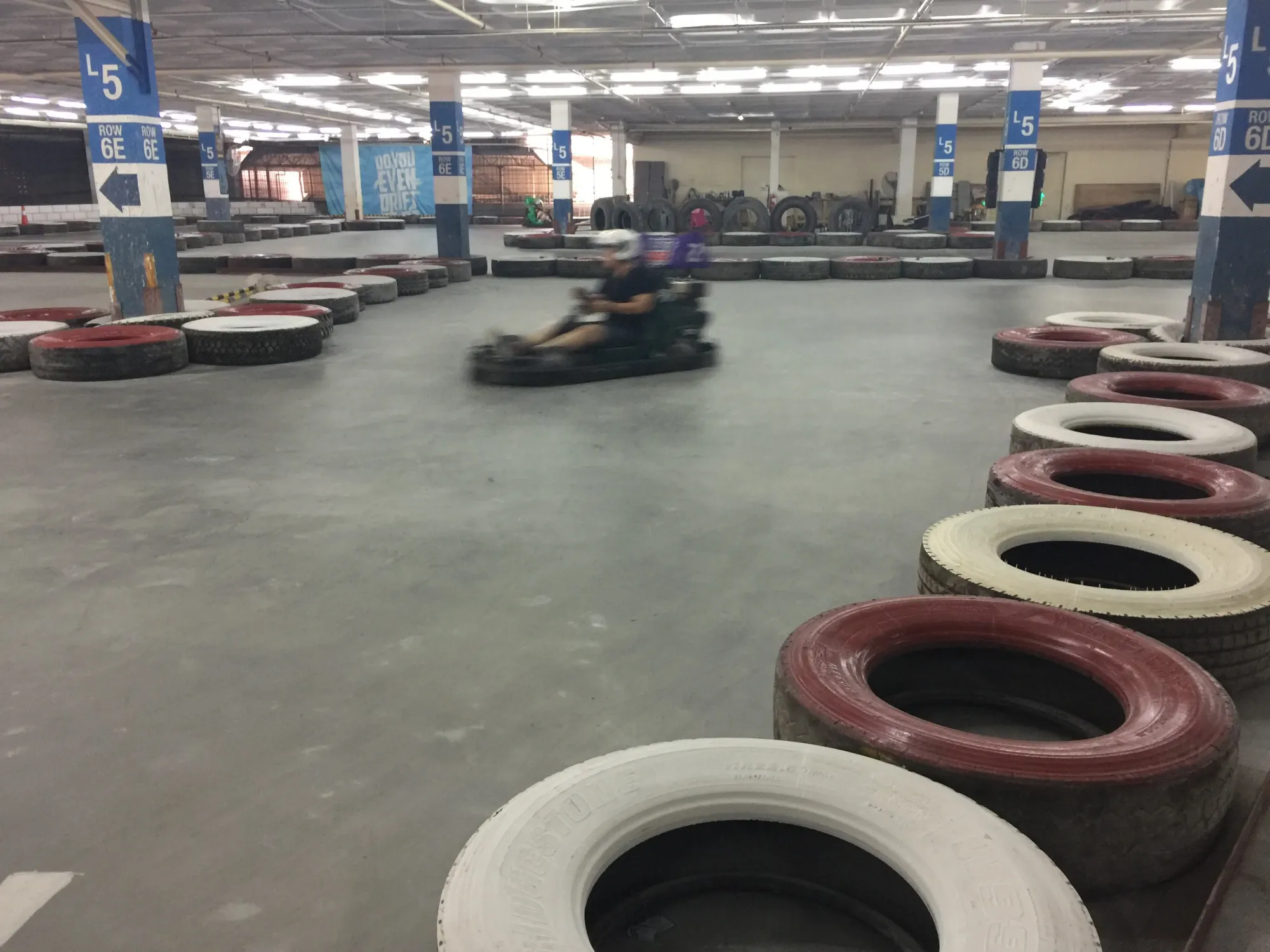 Go-kart racer speeding through indoor track
