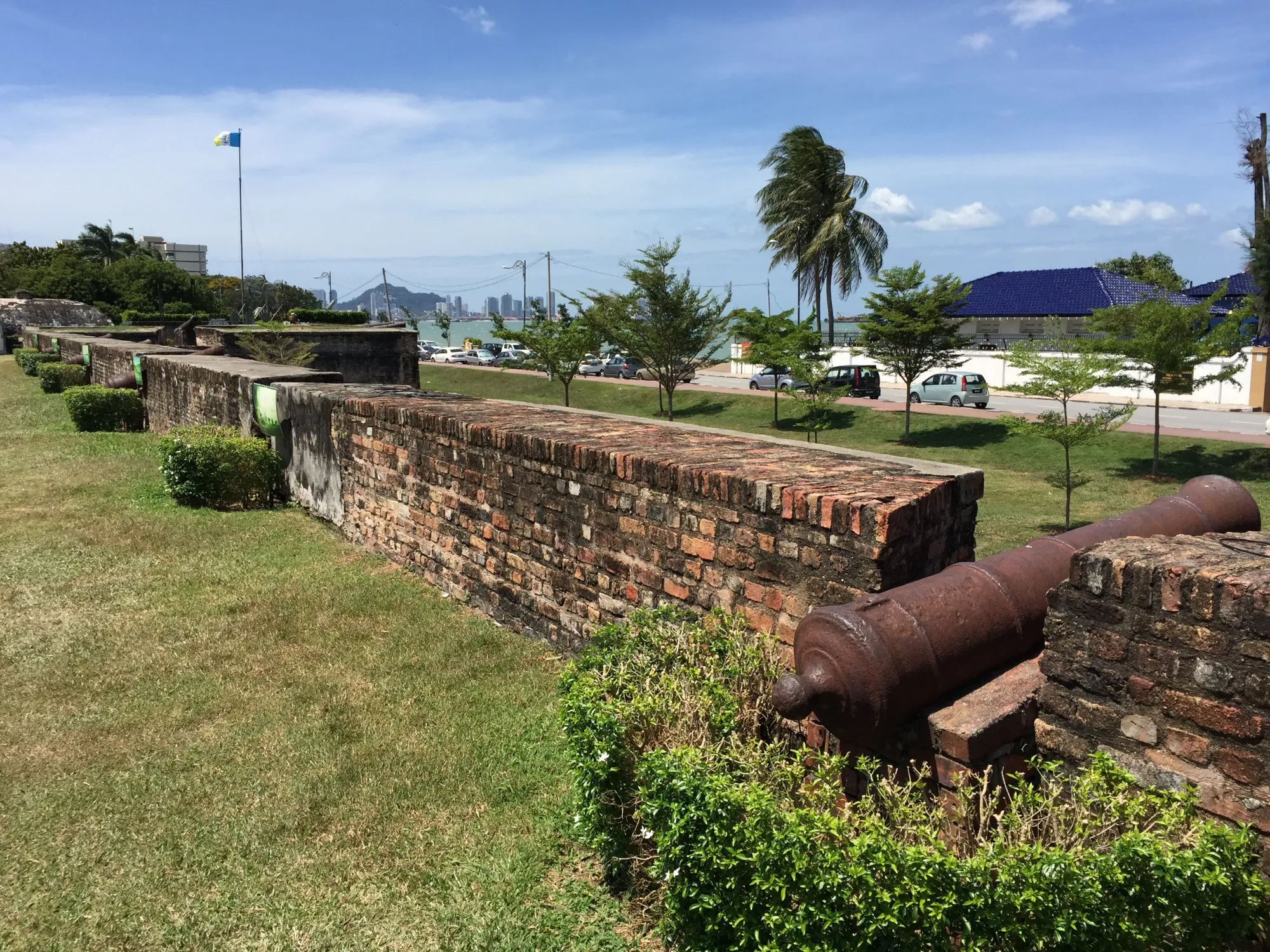 Historic brick fort with cannon overlooking harbor