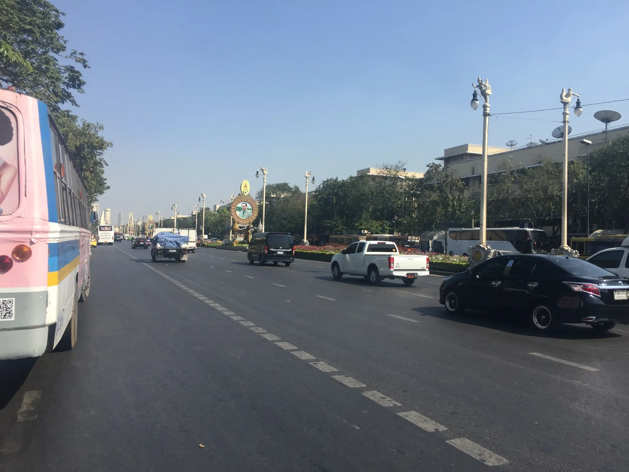 Traffic on wide boulevard with ornate street lamps