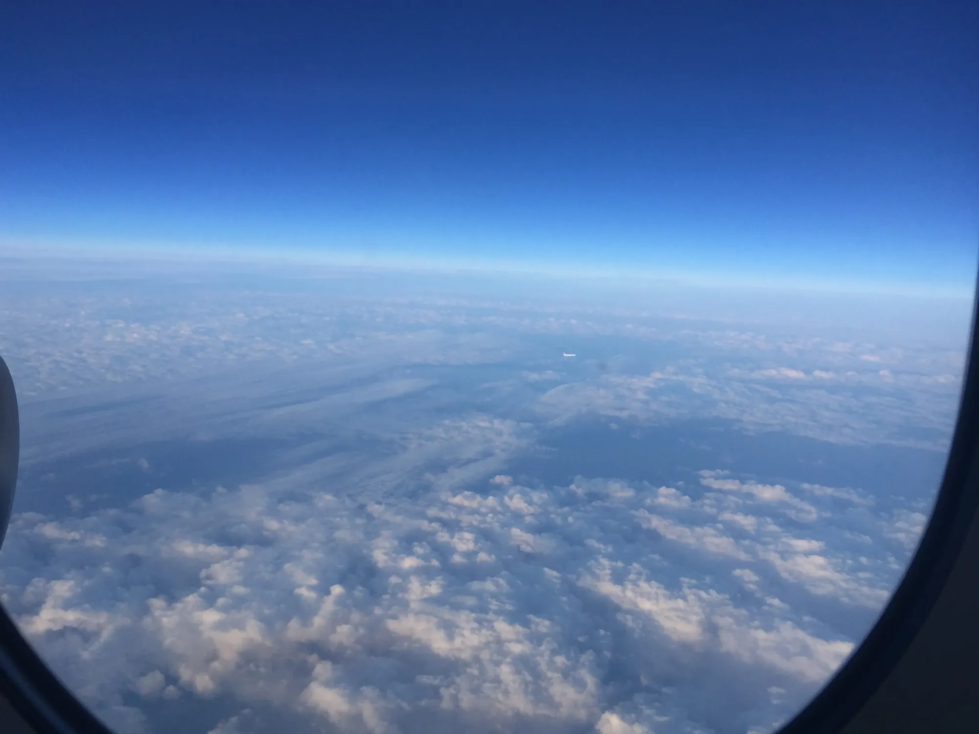 Aerial view of a river winding through clouds and landscape