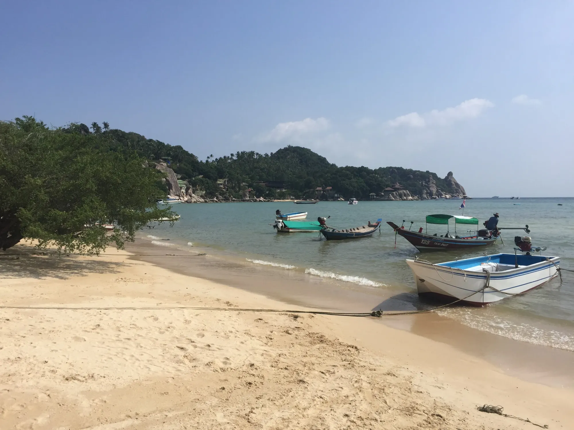 Fishing boats anchored in turquoise bay