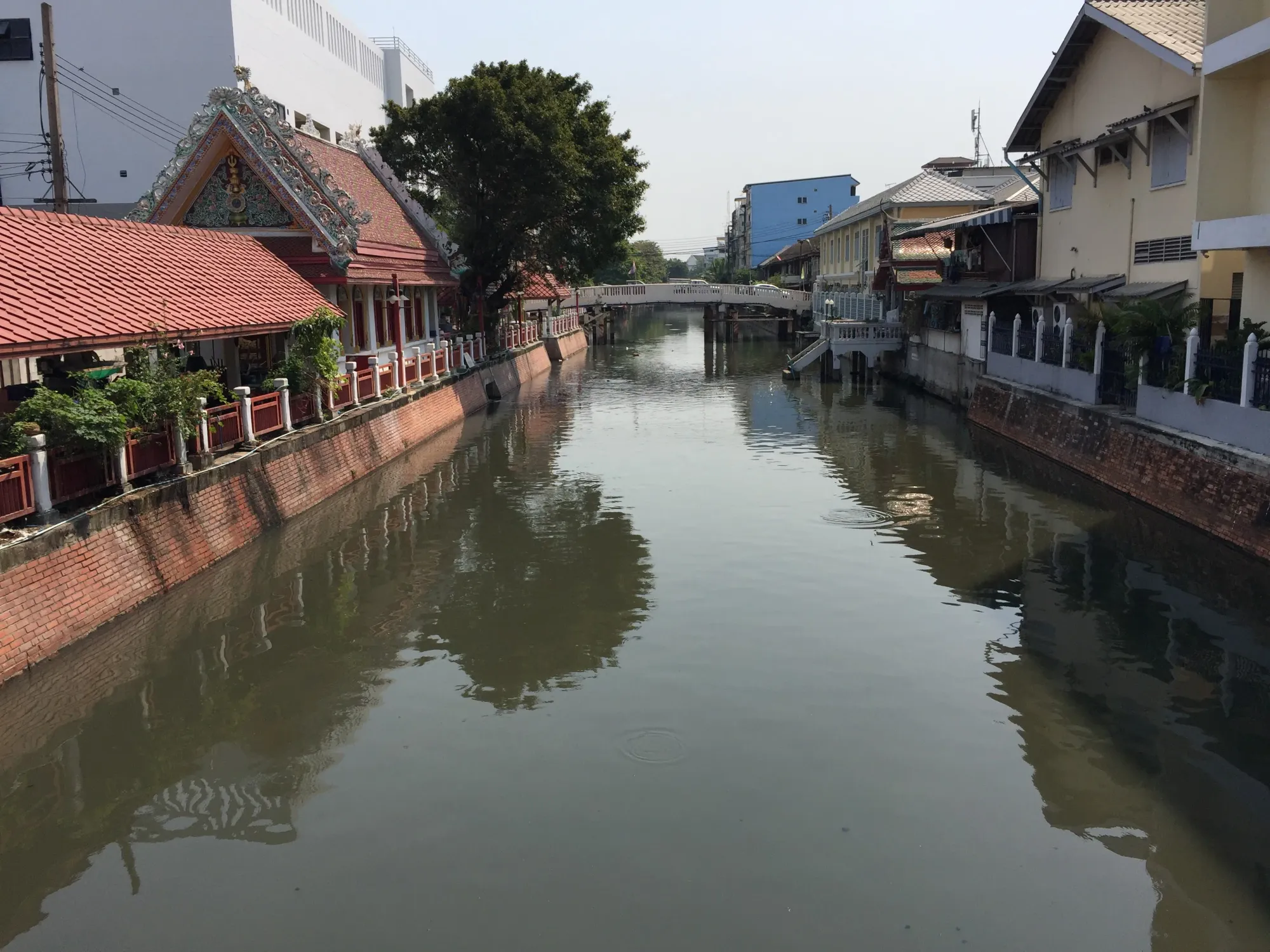 Canal with traditional Thai temple and colonial buildings