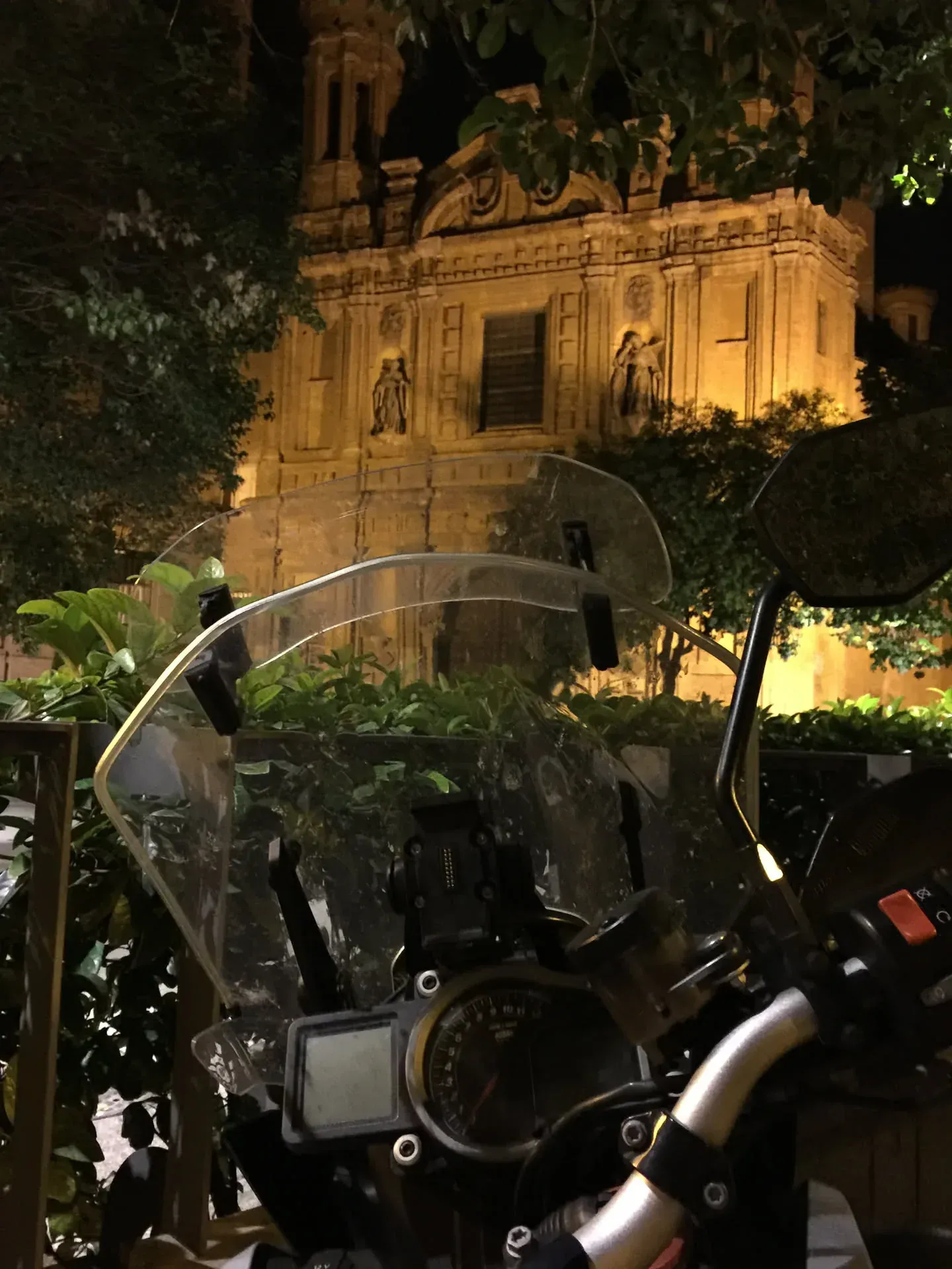 Motorcycle windshield with illuminated historic building, Centro Aragon