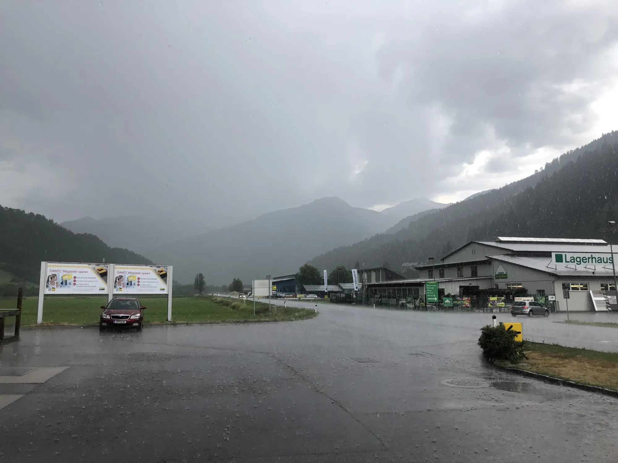 Into the thunderstorm — Austrian valley in rain, late afternoon.