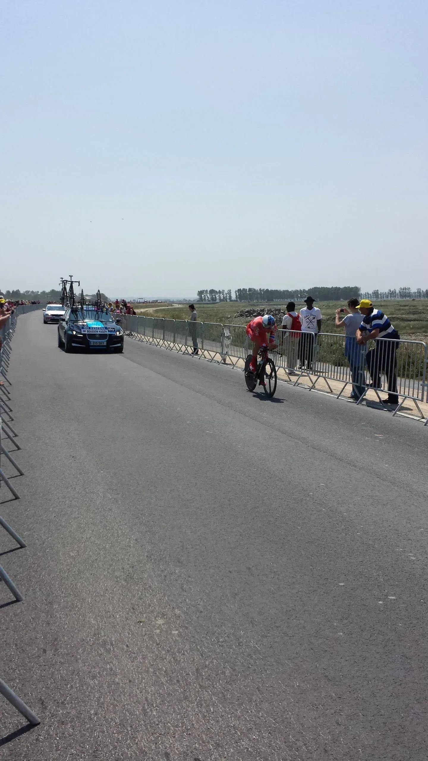 Cyclist riding past cheering spectators at Tour de France