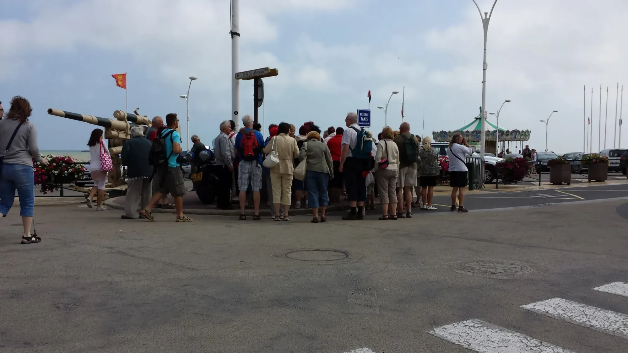 Tour group gathered at coastal memorial site