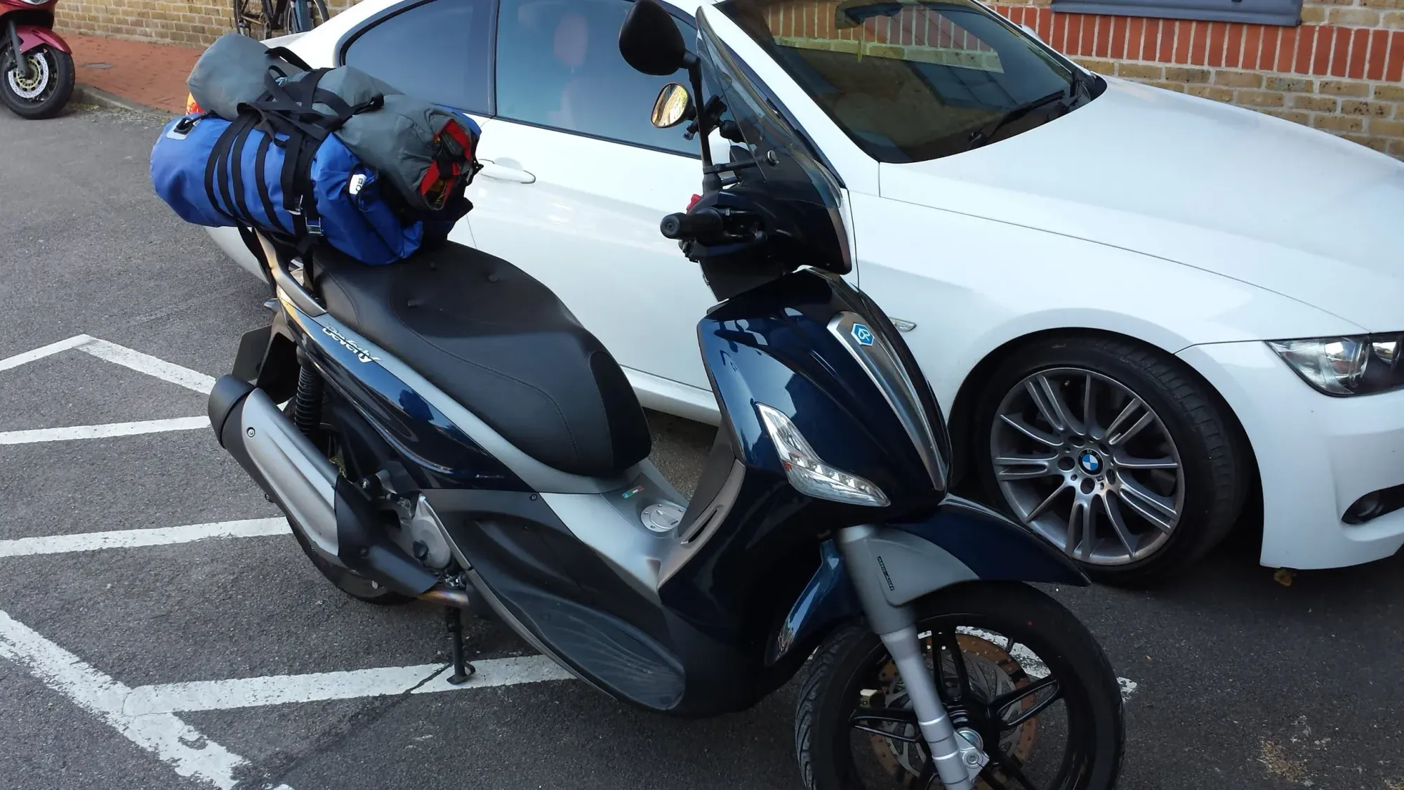 Scooters parked beside white car, Stamshaw