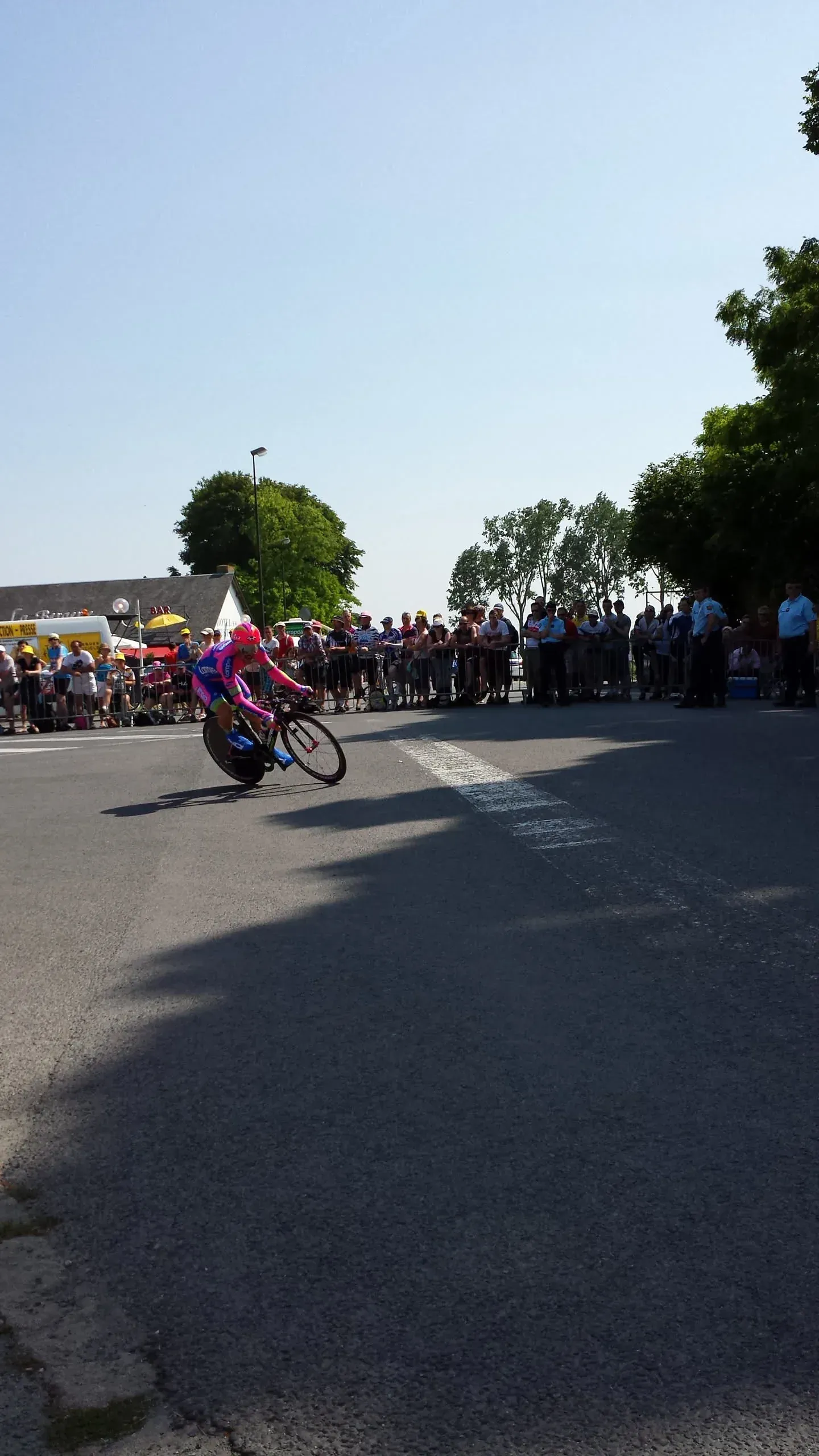 Cyclist racing past crowds near Mont-Saint-Michel, Normandy