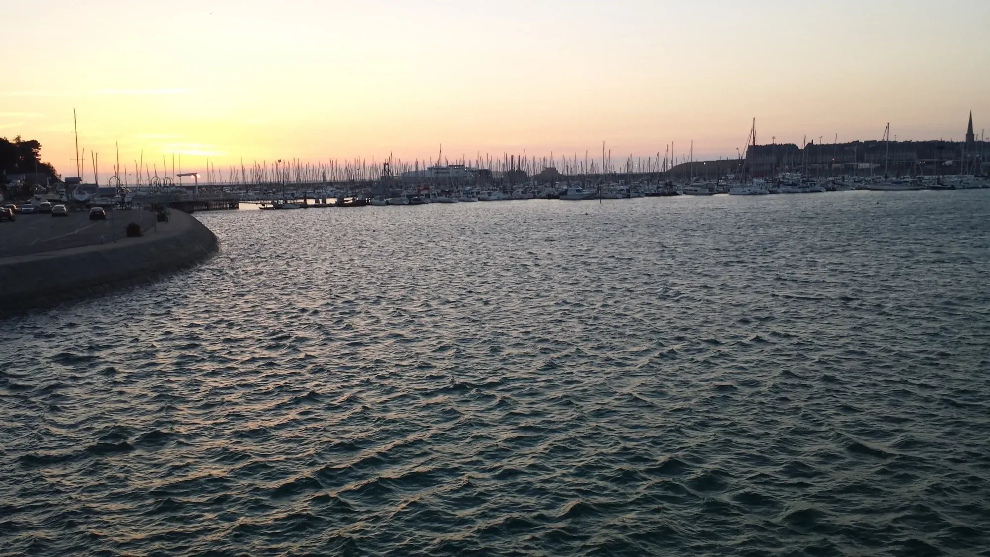 Sailboats in marina at sunset