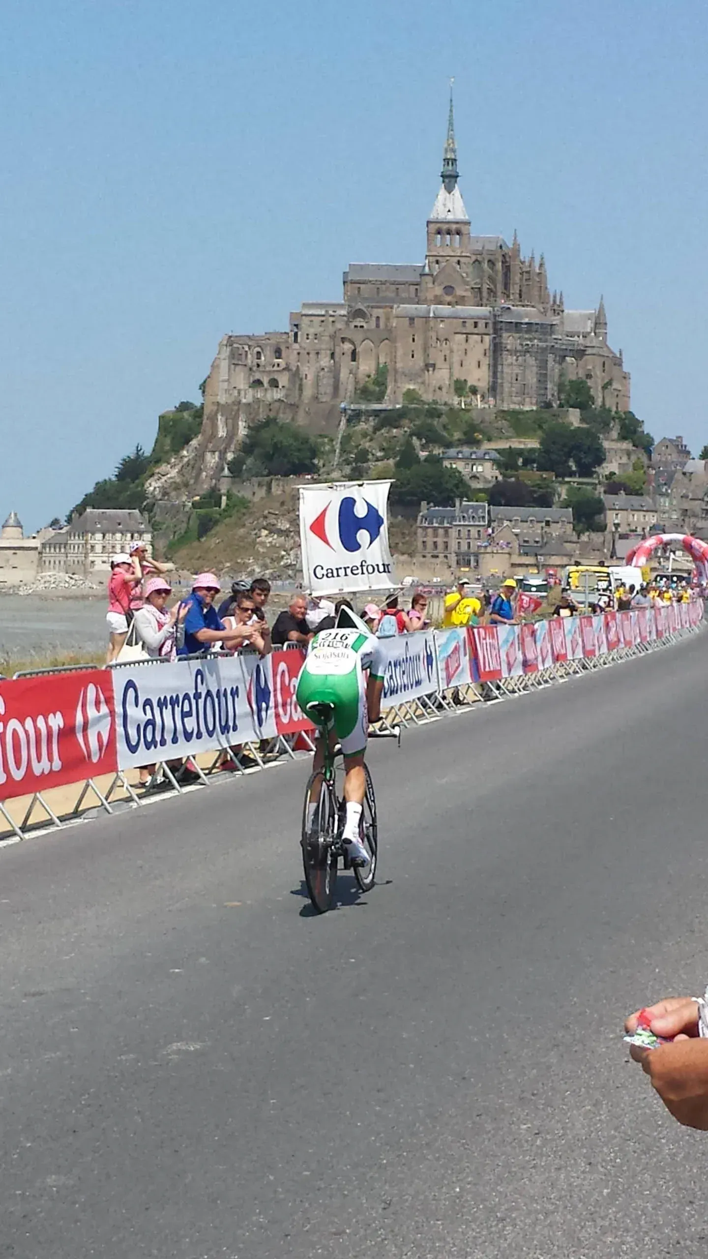 Cyclist riding past Mont-Saint-Michel during Tour de France
