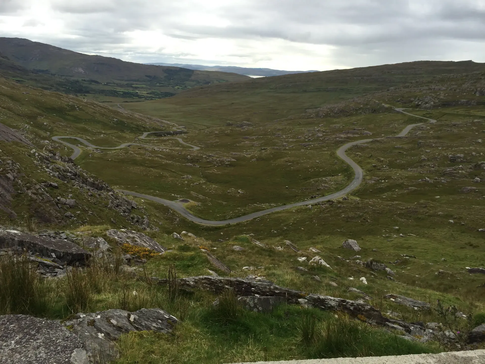 Winding road through green valley at Adrigole