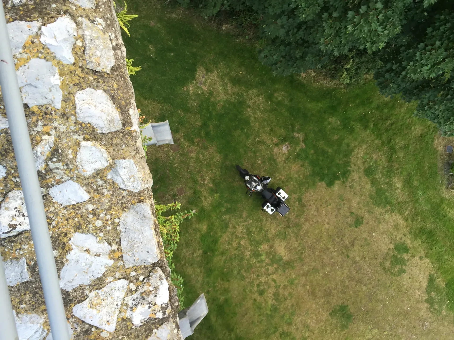 Motorcycle parked by old stone wall, Midleton Rural