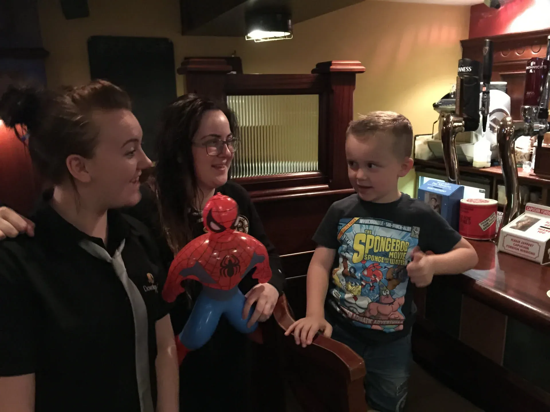 Two women and young boy in pub at Downings, Ireland
