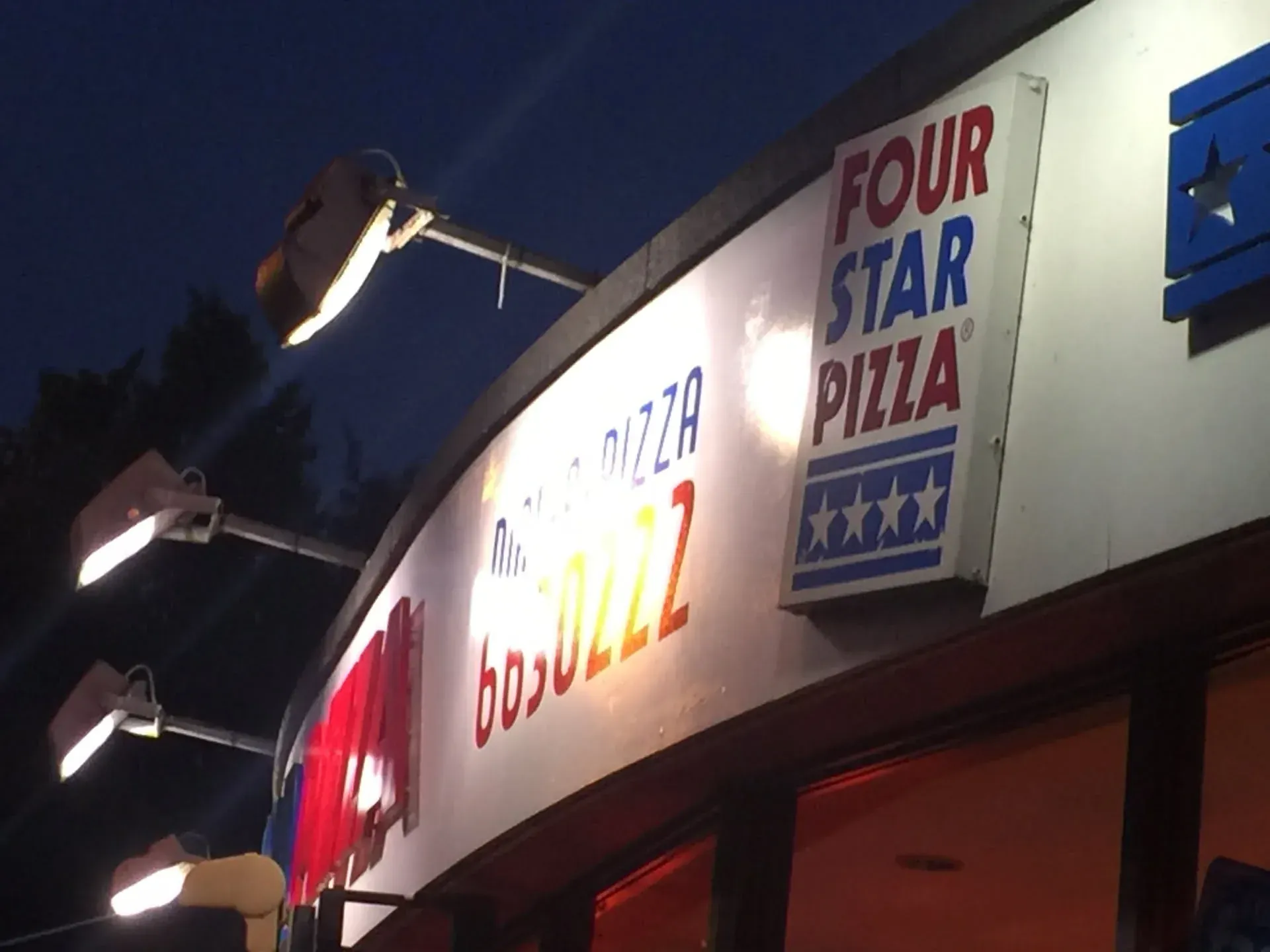 Four Star Pizza sign at night, Killarney