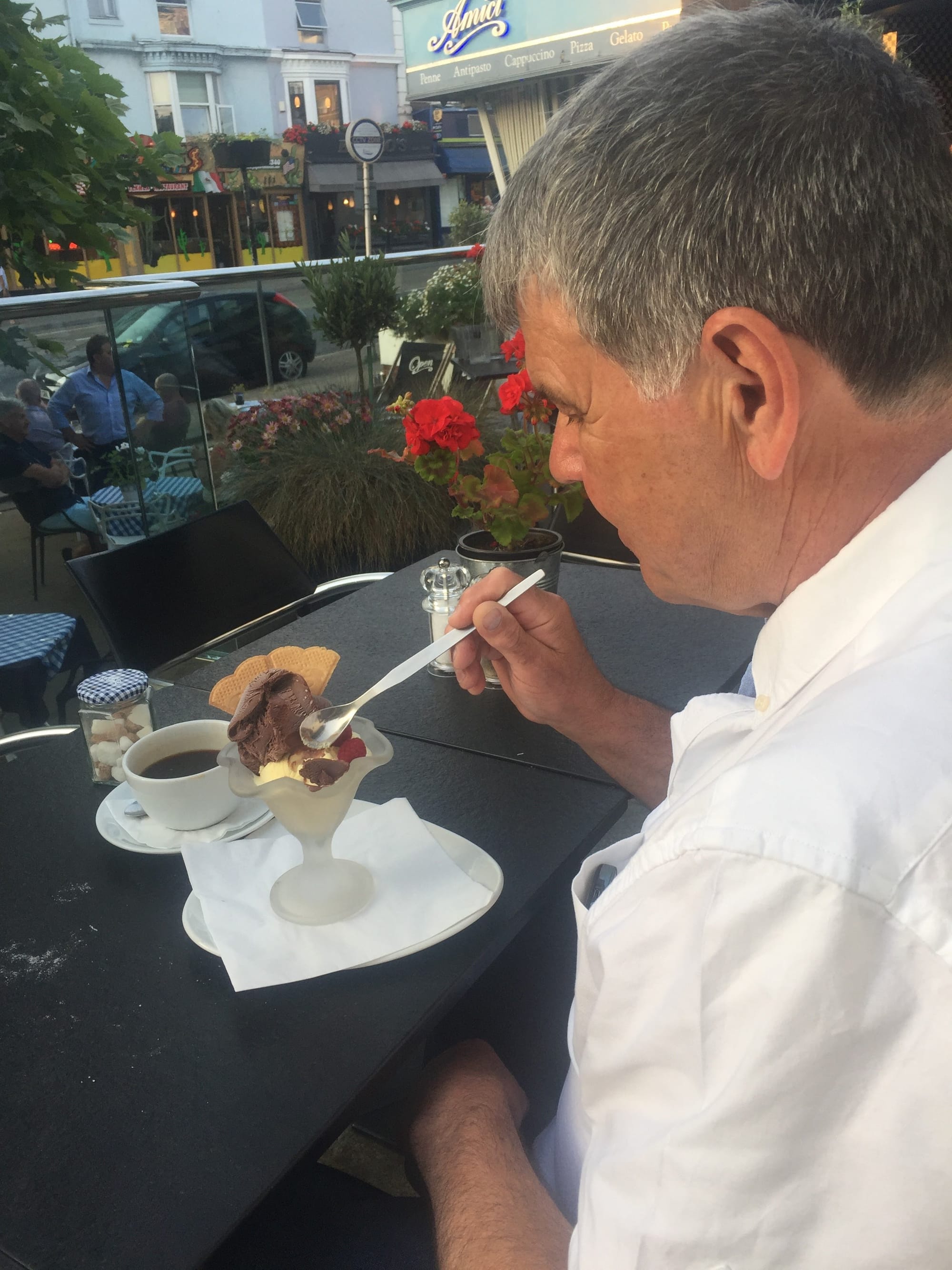 Man enjoying dessert at Ellacombe café terrace
