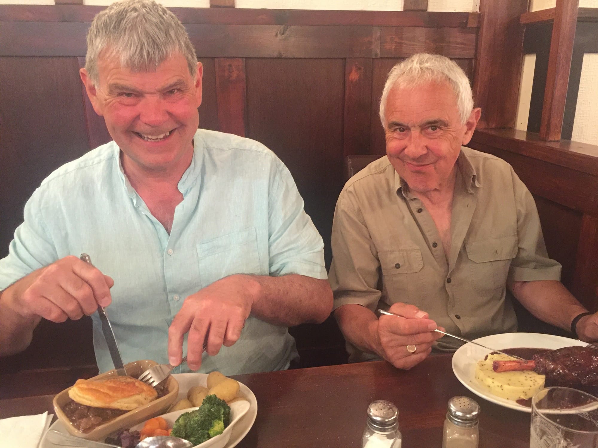 Two men enjoying dinner at Alcombe, England
