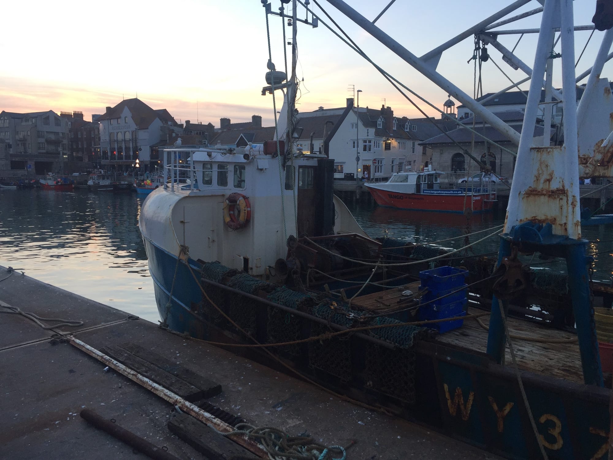 Fishing boats moored at Rodwell harbor at dusk