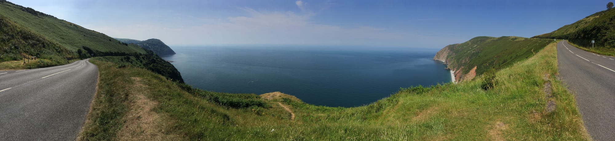 Coastal road curving between green cliffs at Lynton