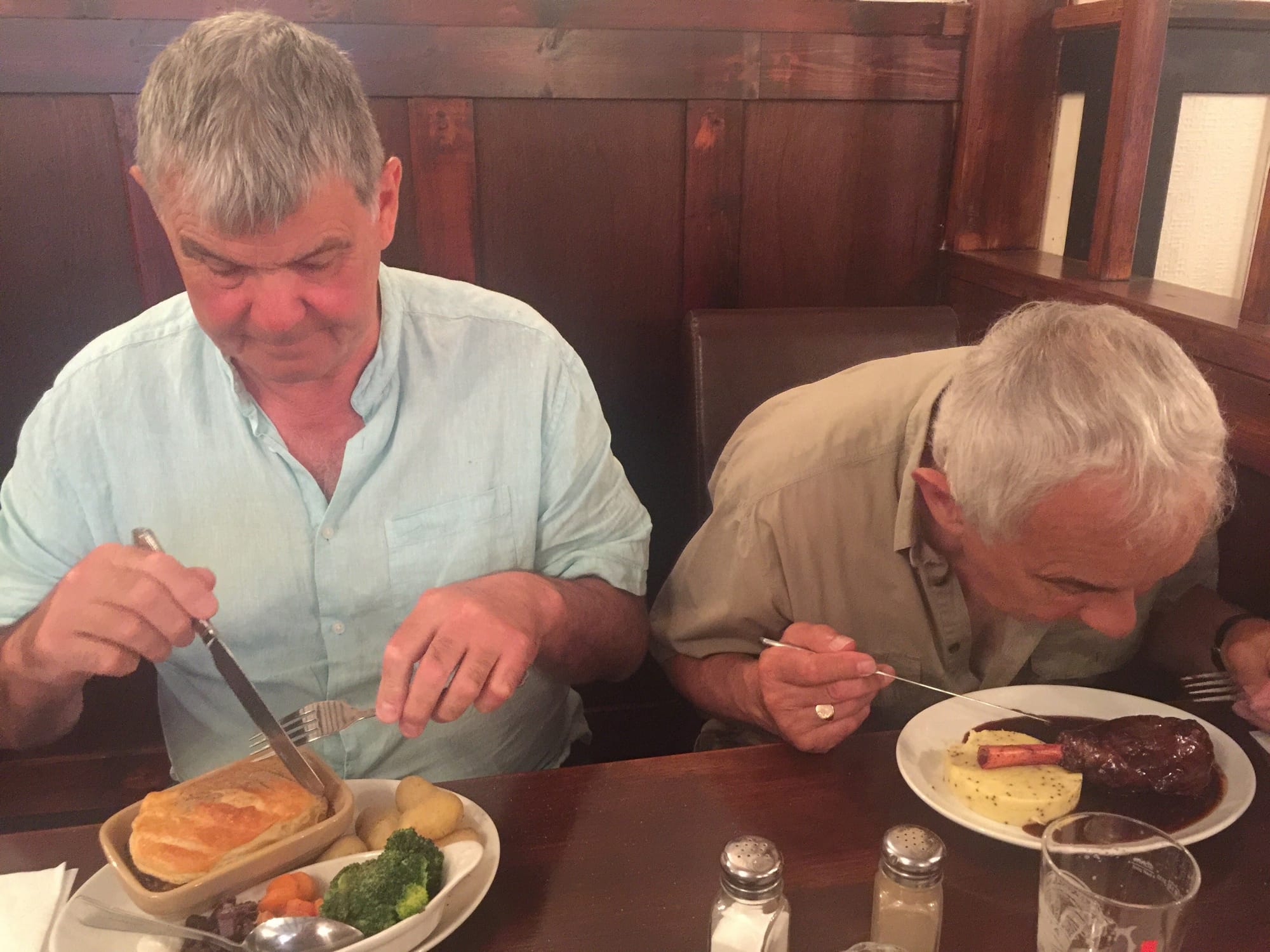 Two older men dining at Alcombe, England