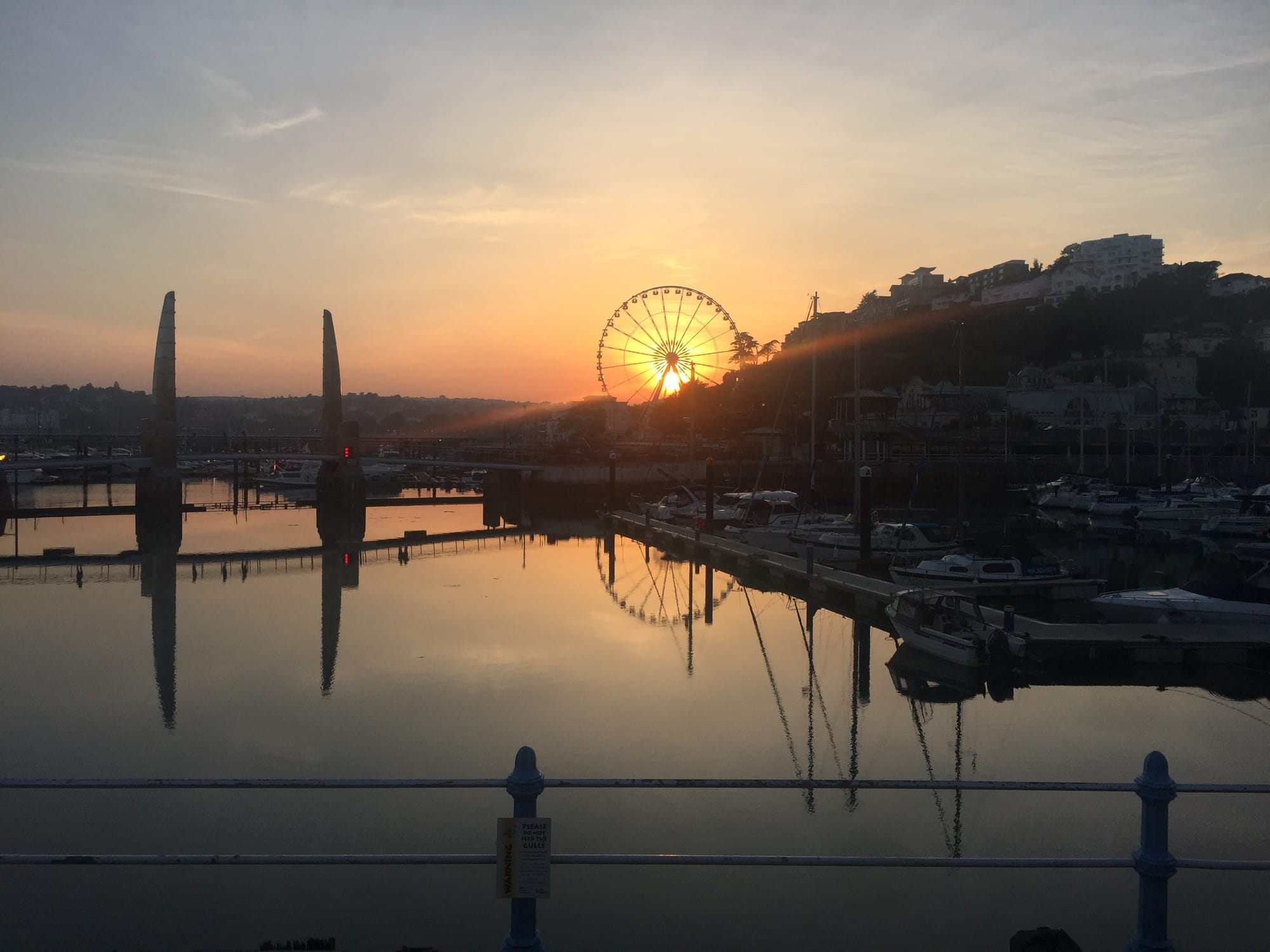 Sunrise at Ellacombe harbor with Ferris wheel reflection